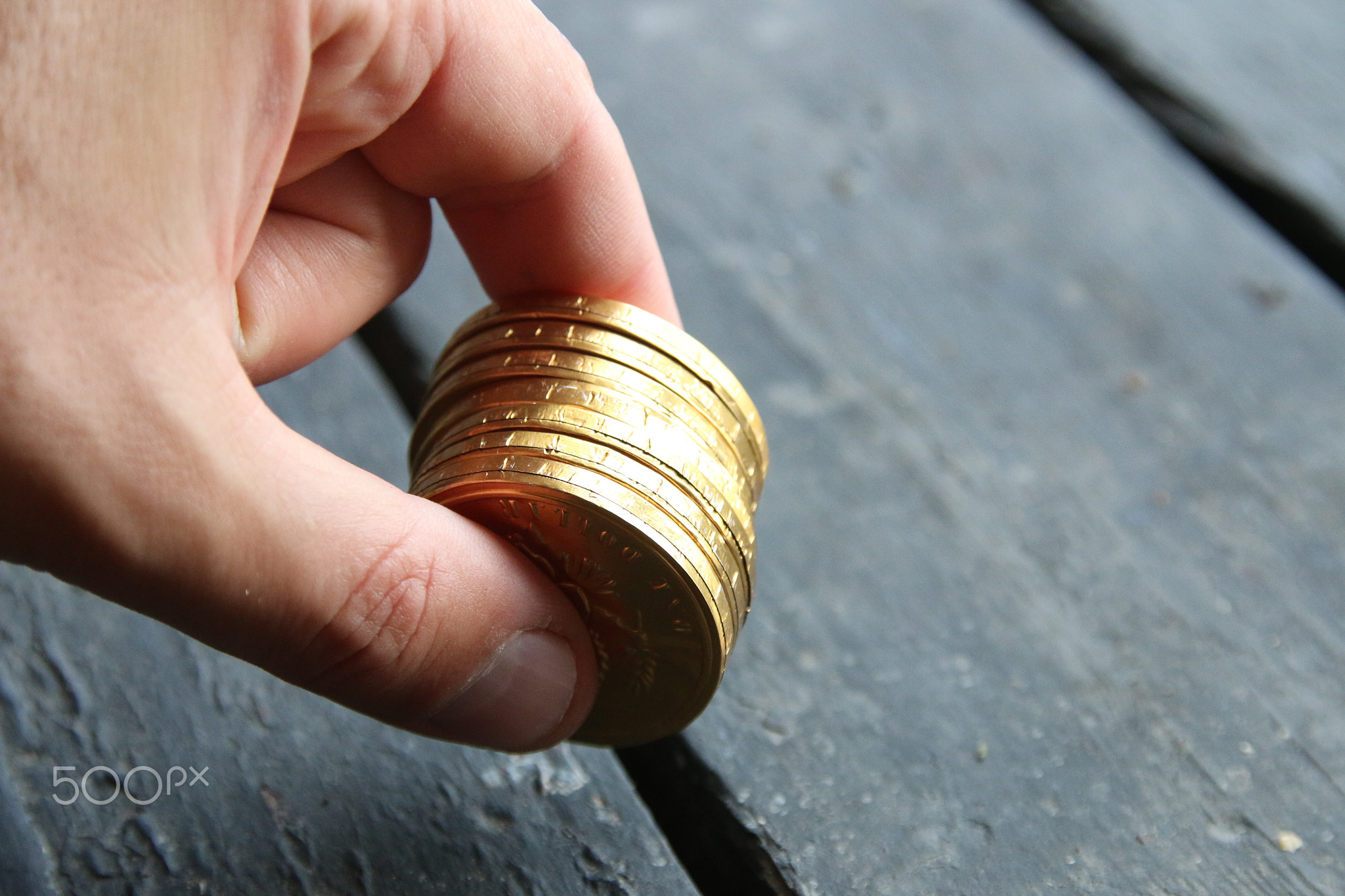 Business profit concept. Businessman holds gold coins.