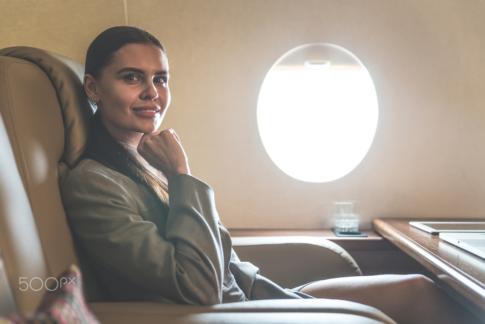 Business woman traveling and working on the private jet