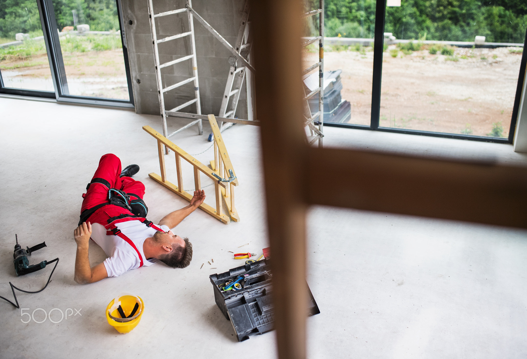 An accident of a man worker at the construction site.
