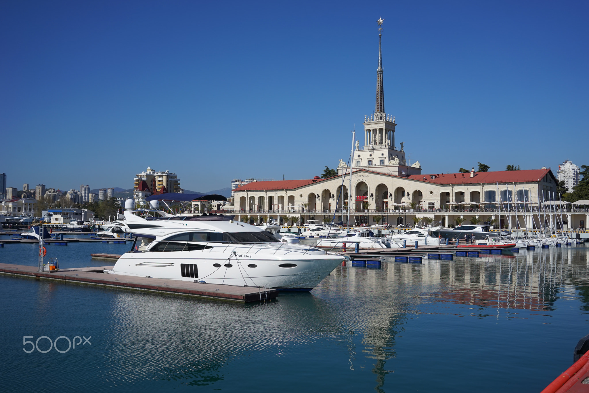 Beautiful yacht on the background of the sights of the resort city at the seaport.