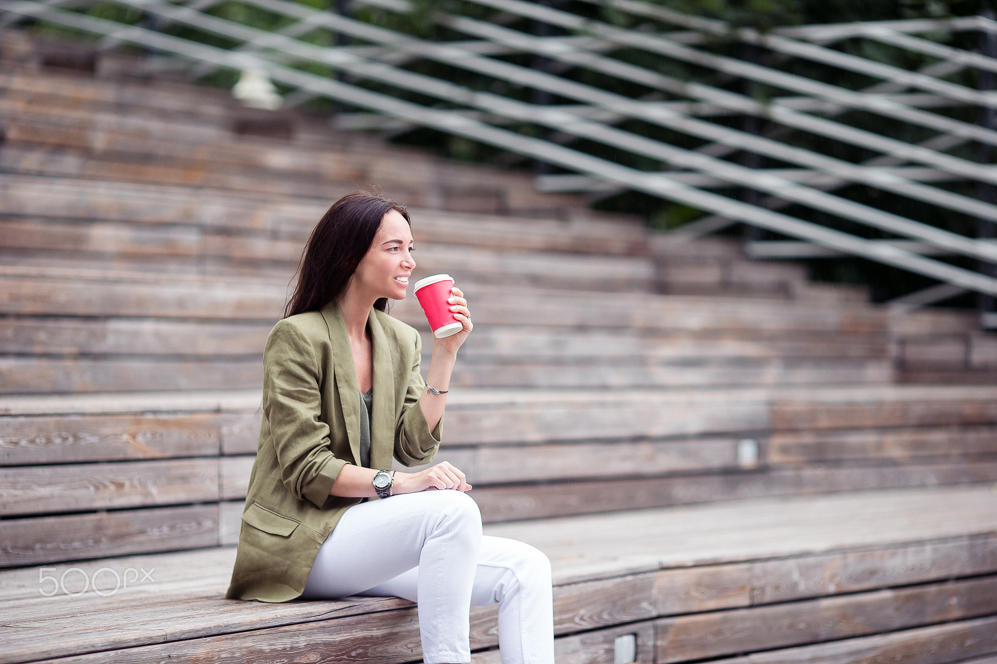 Woman drinking tasty coffee outdoors in the park