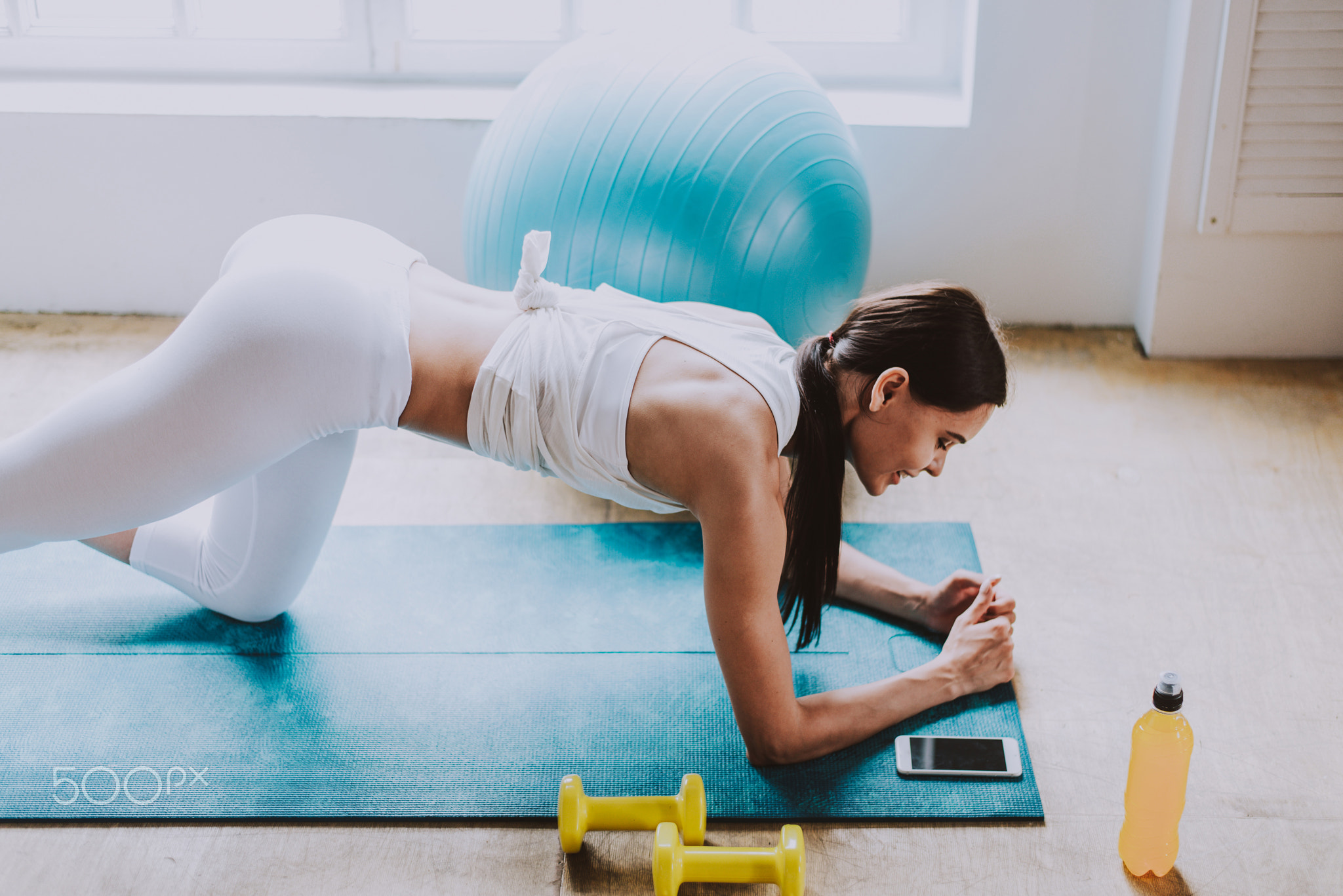 Beautiful girl making training and yoga at home in the morning