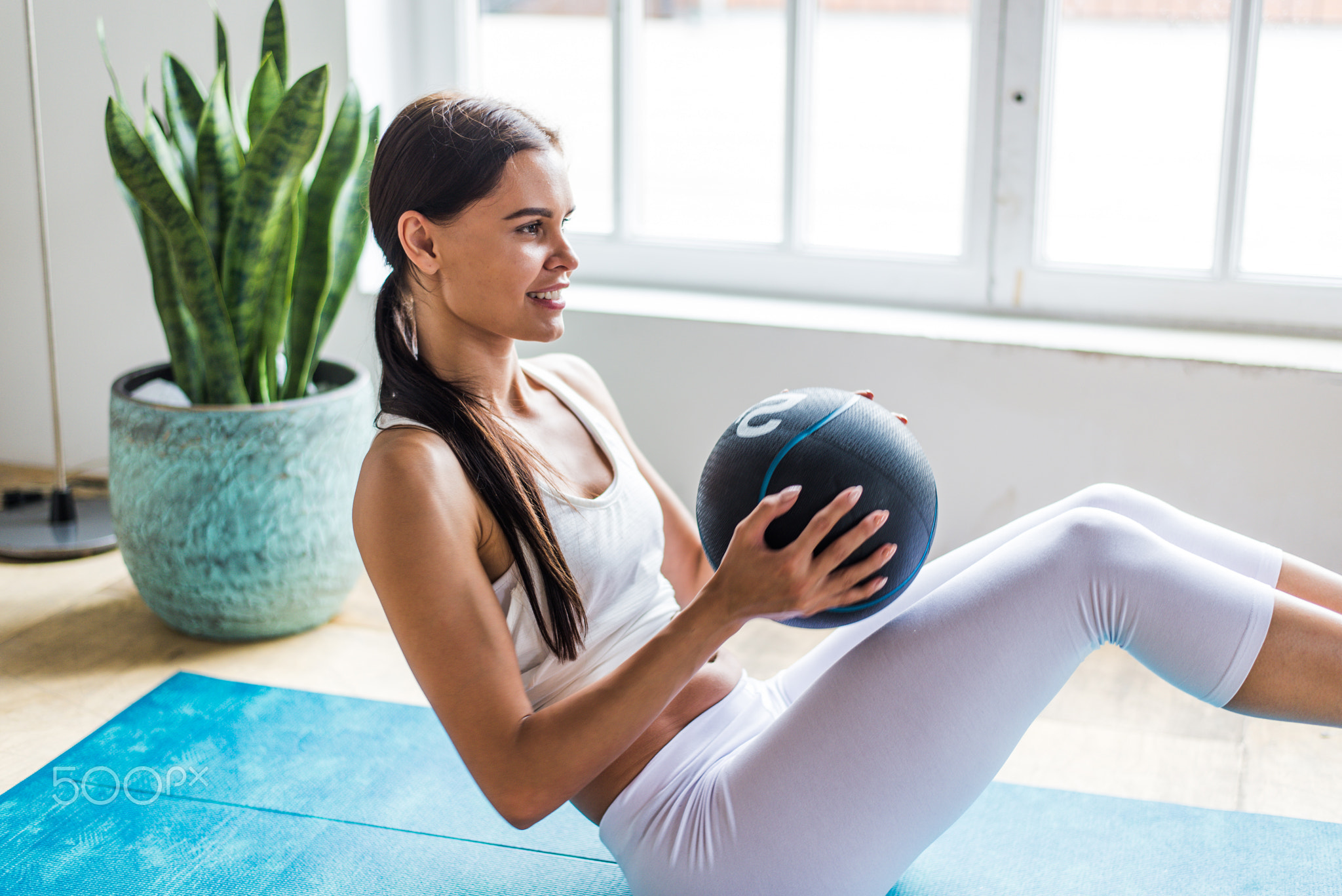 Beautiful girl making training and yoga at home in the morning