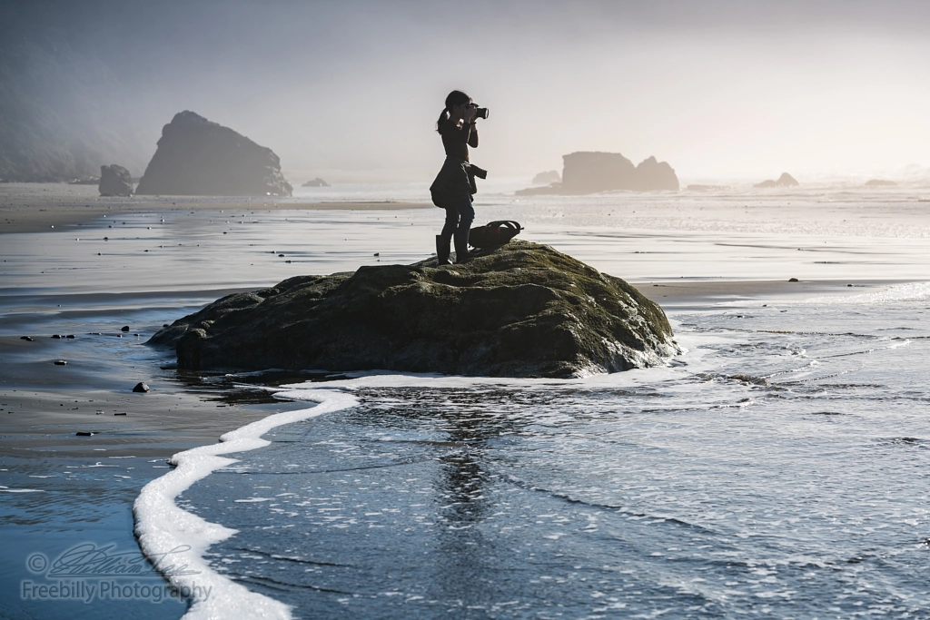 Young girl on beach taking photos of Pacific Ocean in Oregon coast by William Freebilly photography ✅ on 500px.com