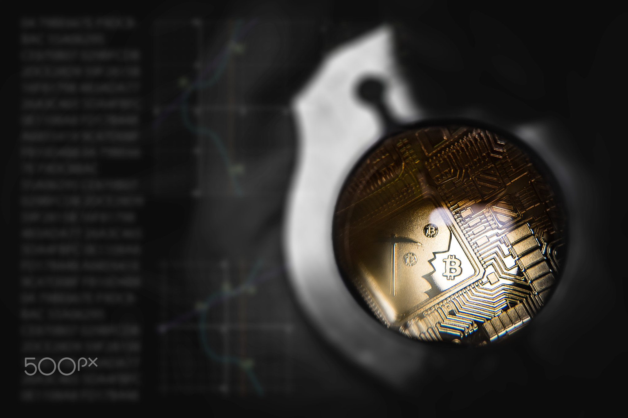 Golden Bitcoin under loupe