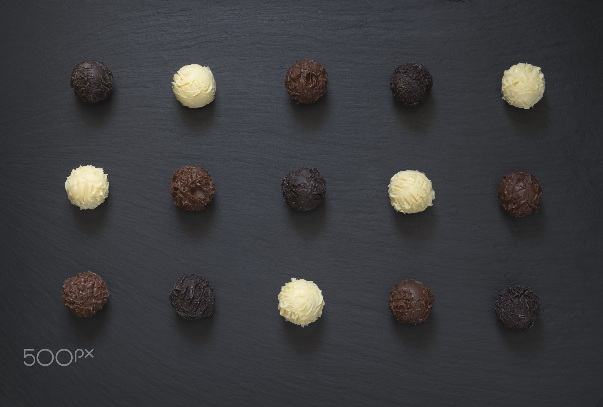 Fancy chocolate truffles ready to eat on black