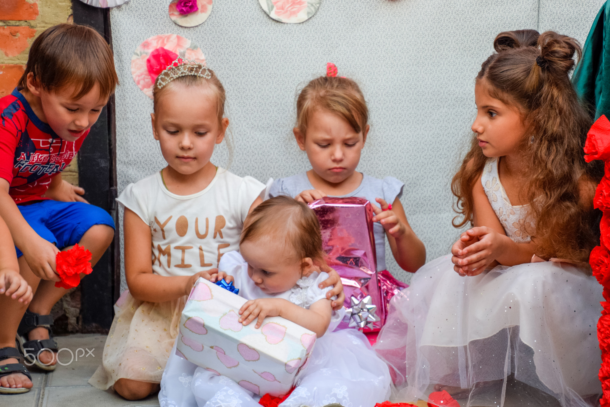 Children are looking boxes with gifts. Childrens holiday