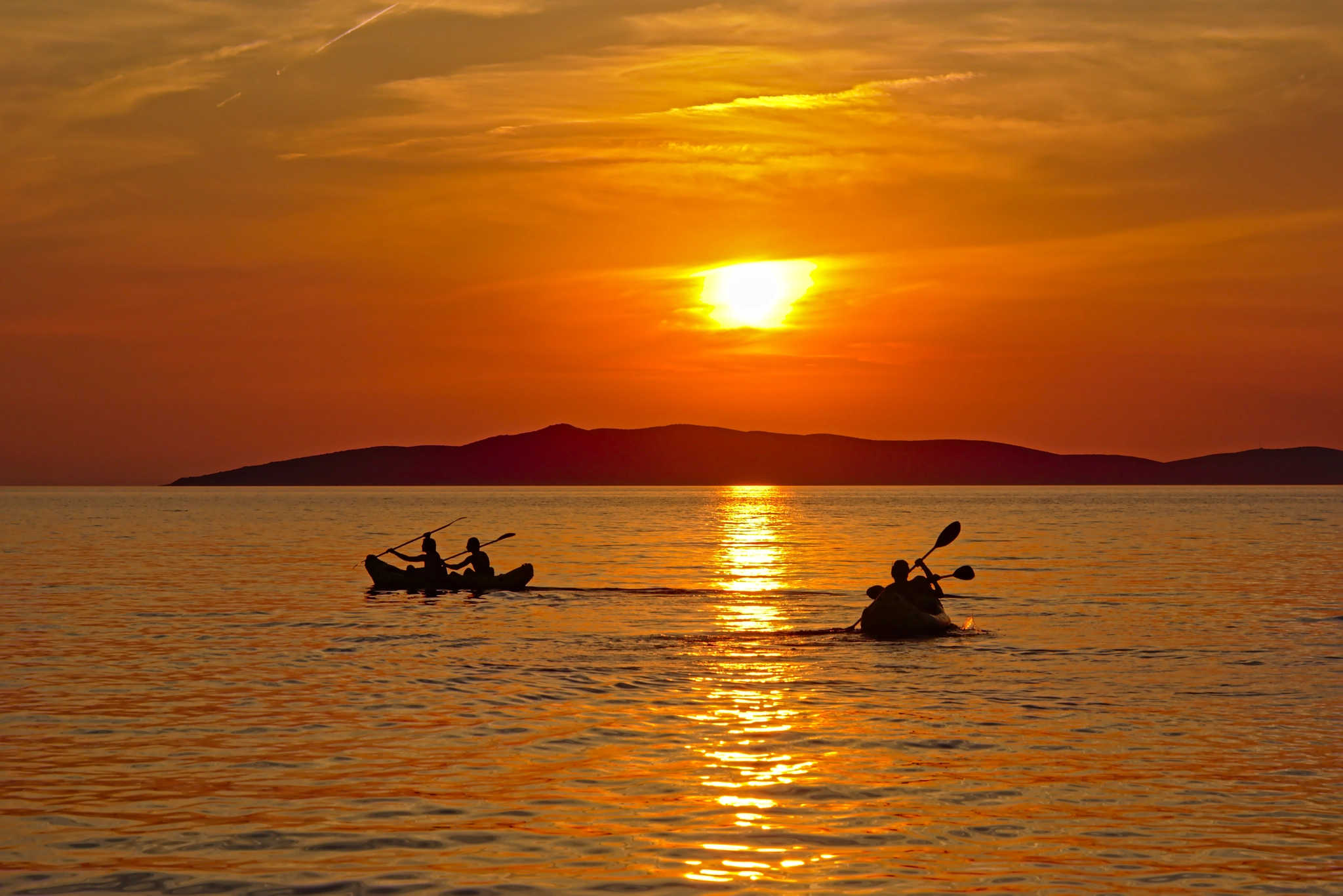 canoeing on the adriatic sea during sunset