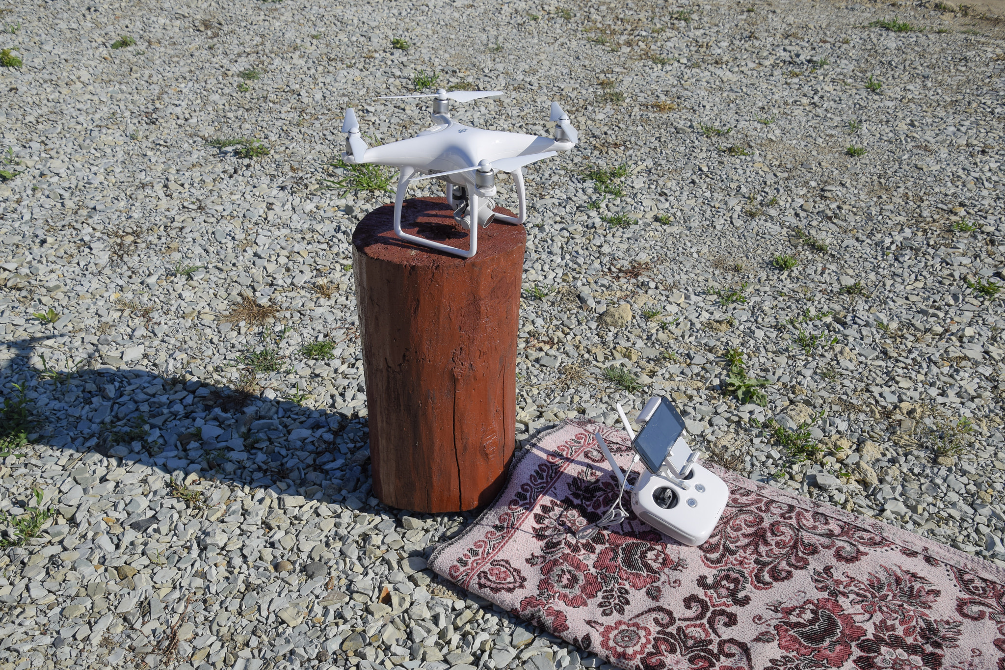 Quadrocopter DJI Phantom 4 on a wooden hemp. Preparing the drone for the flight. Dron is an...