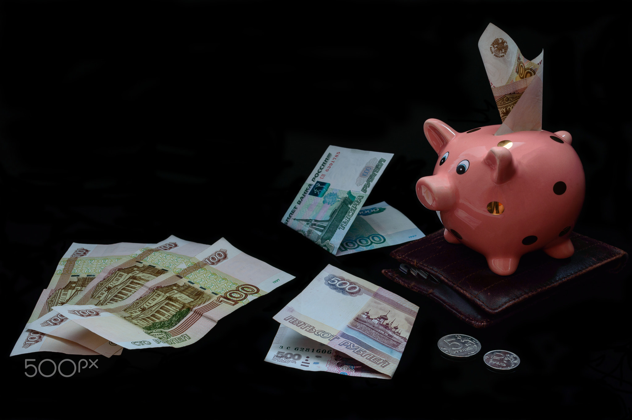 piggy bank on a black background. Rubles