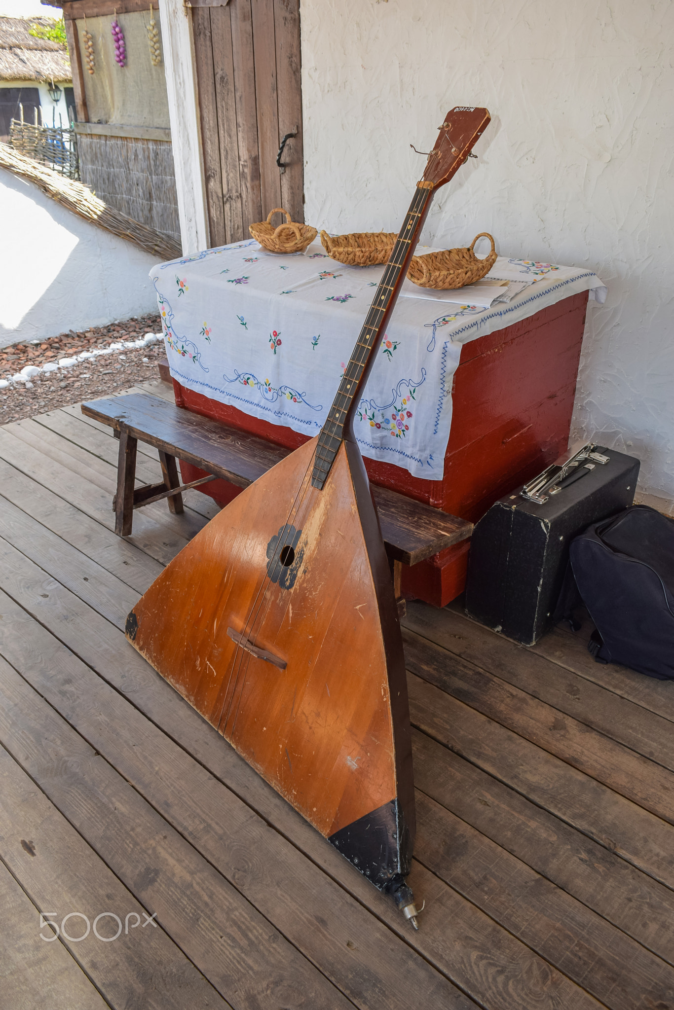 Balalaika-contrabass under a canopy in a cottage
