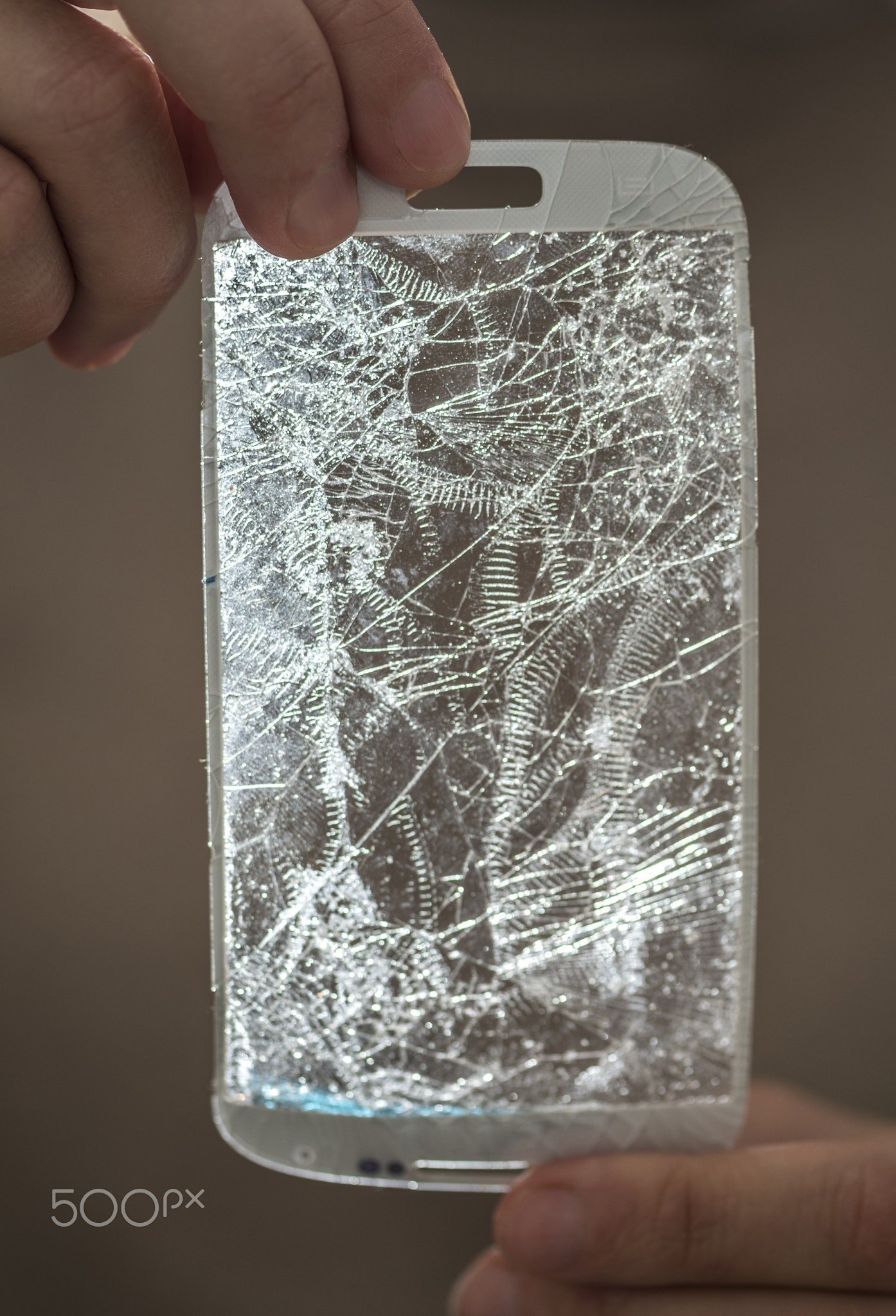 Hands holding a broken screen of smartphon