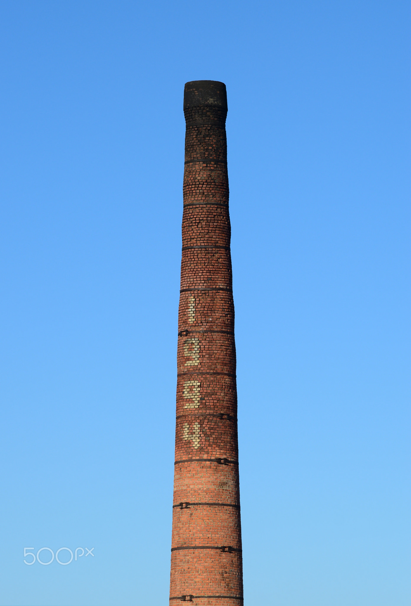 brick factory chimney. Tube for propulsion bricks in the furnace. Pipe on a background of blue sky