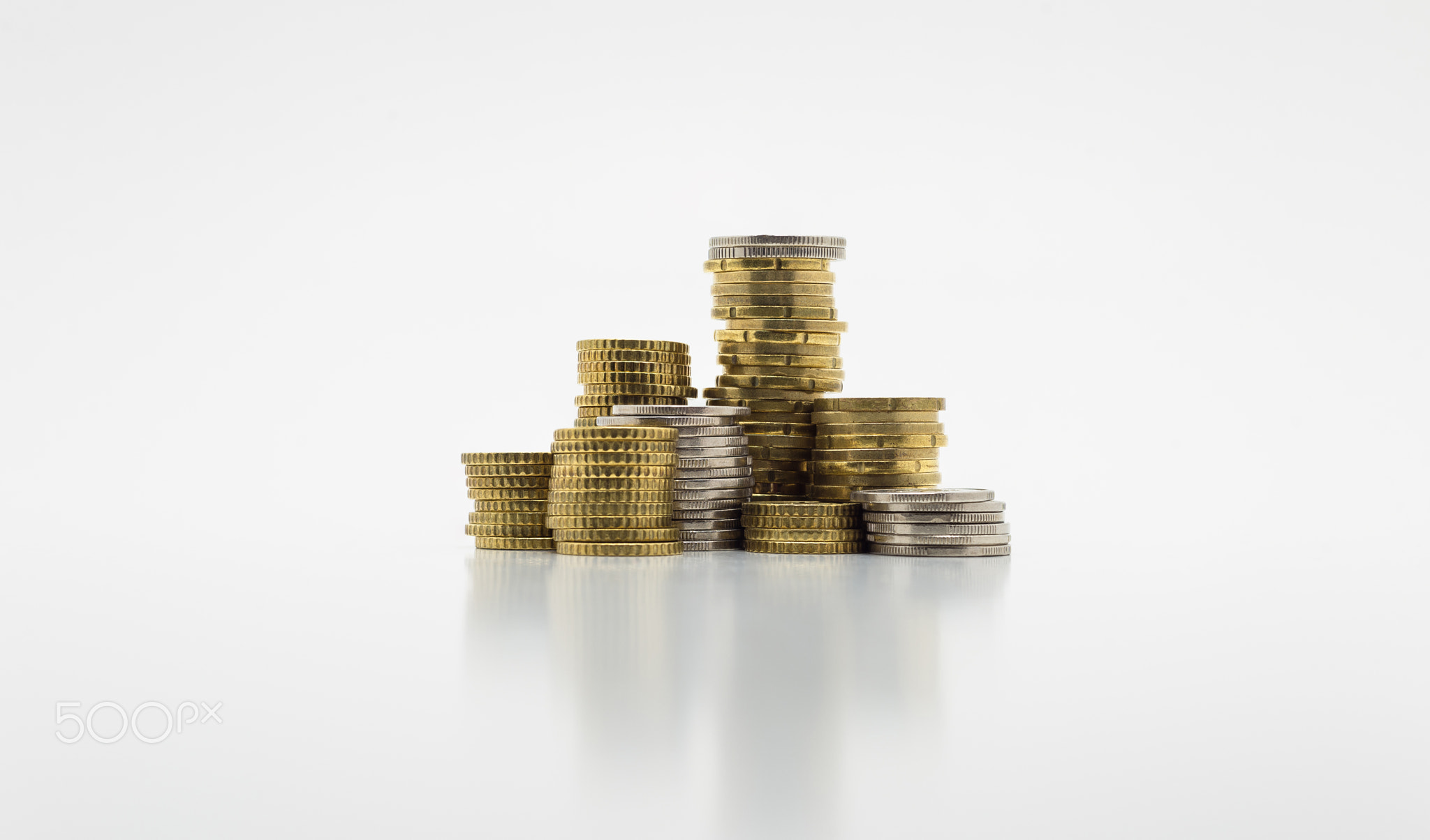 Stack of gold and silver coins isolated on white b