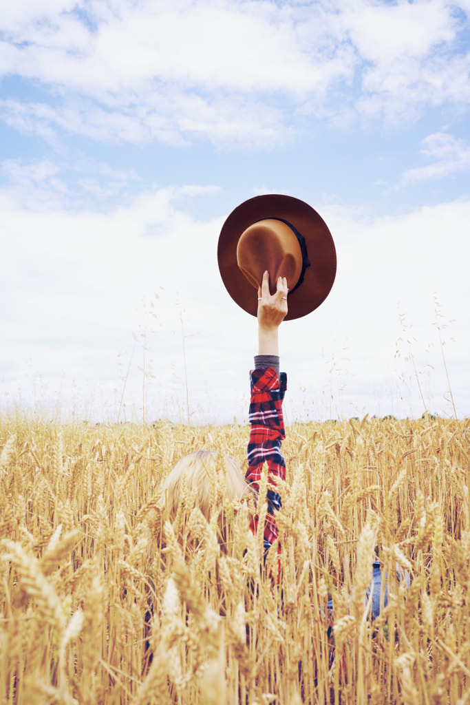 Back view of a young woman in a field of wheat by Sol Vazquez Cantero on 500px.com