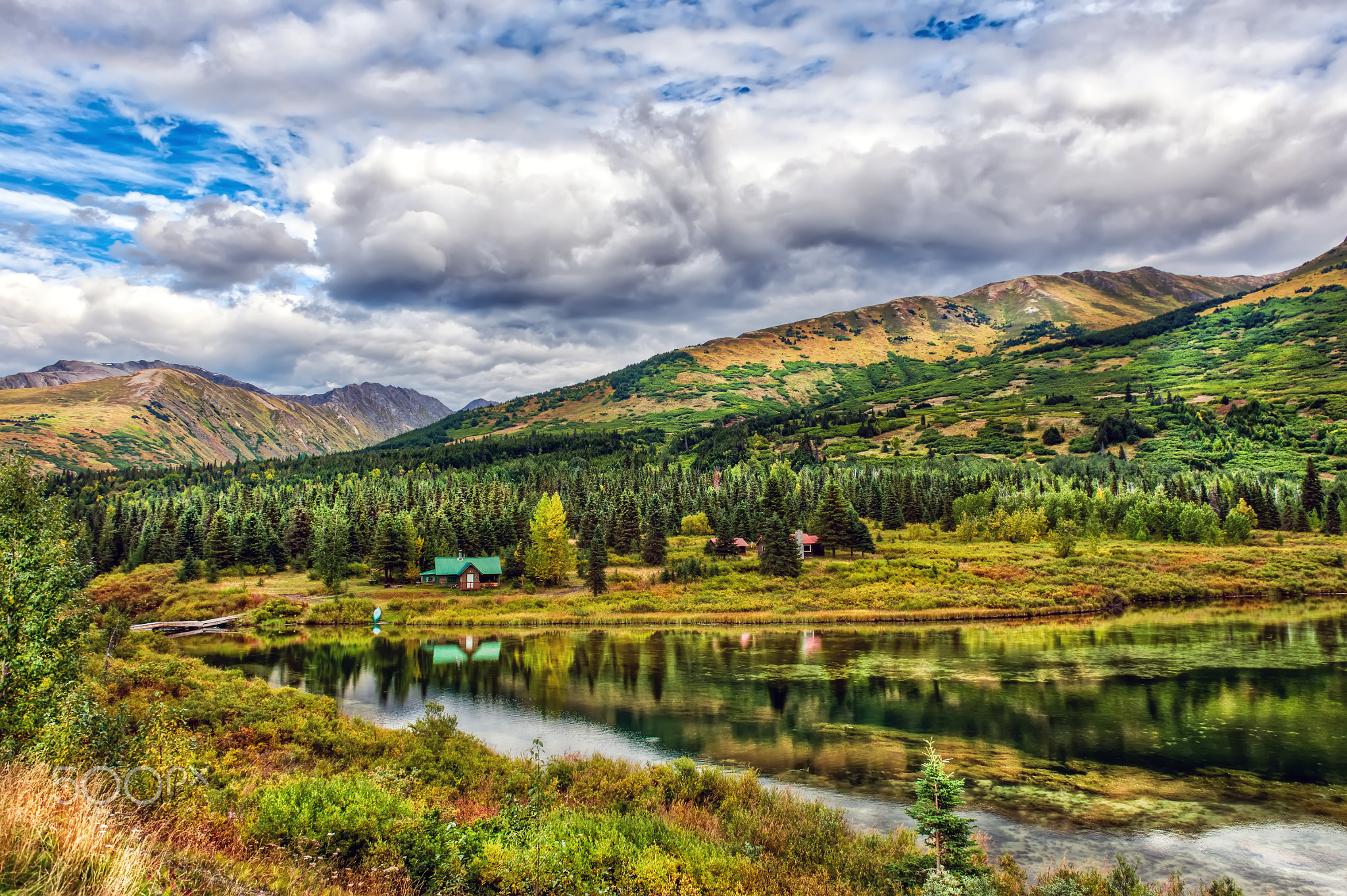 Idyllic Log Cabin by a lake in the Alaskan Wilderness