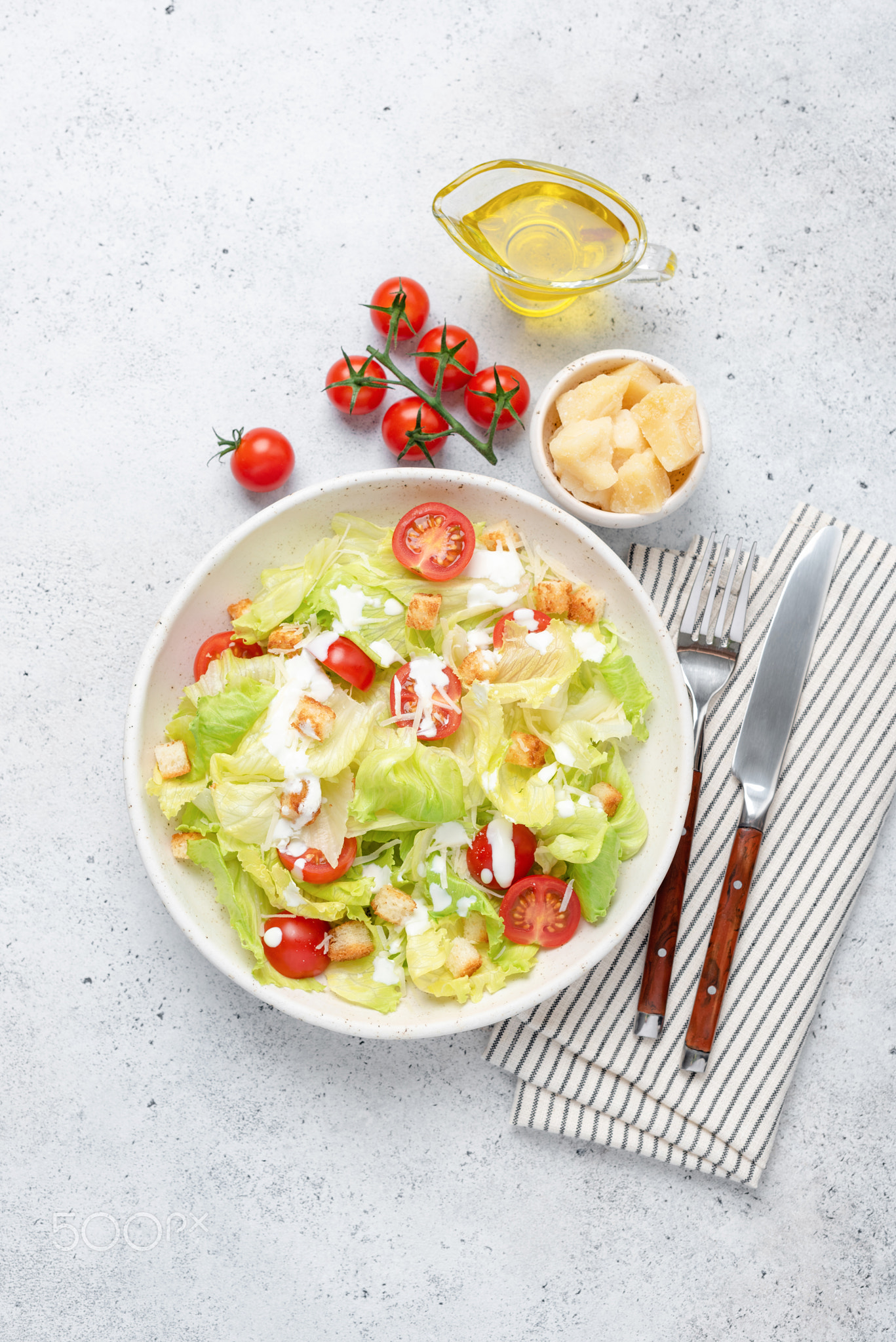 Tasty Caesar salad with chicken on plate, top view