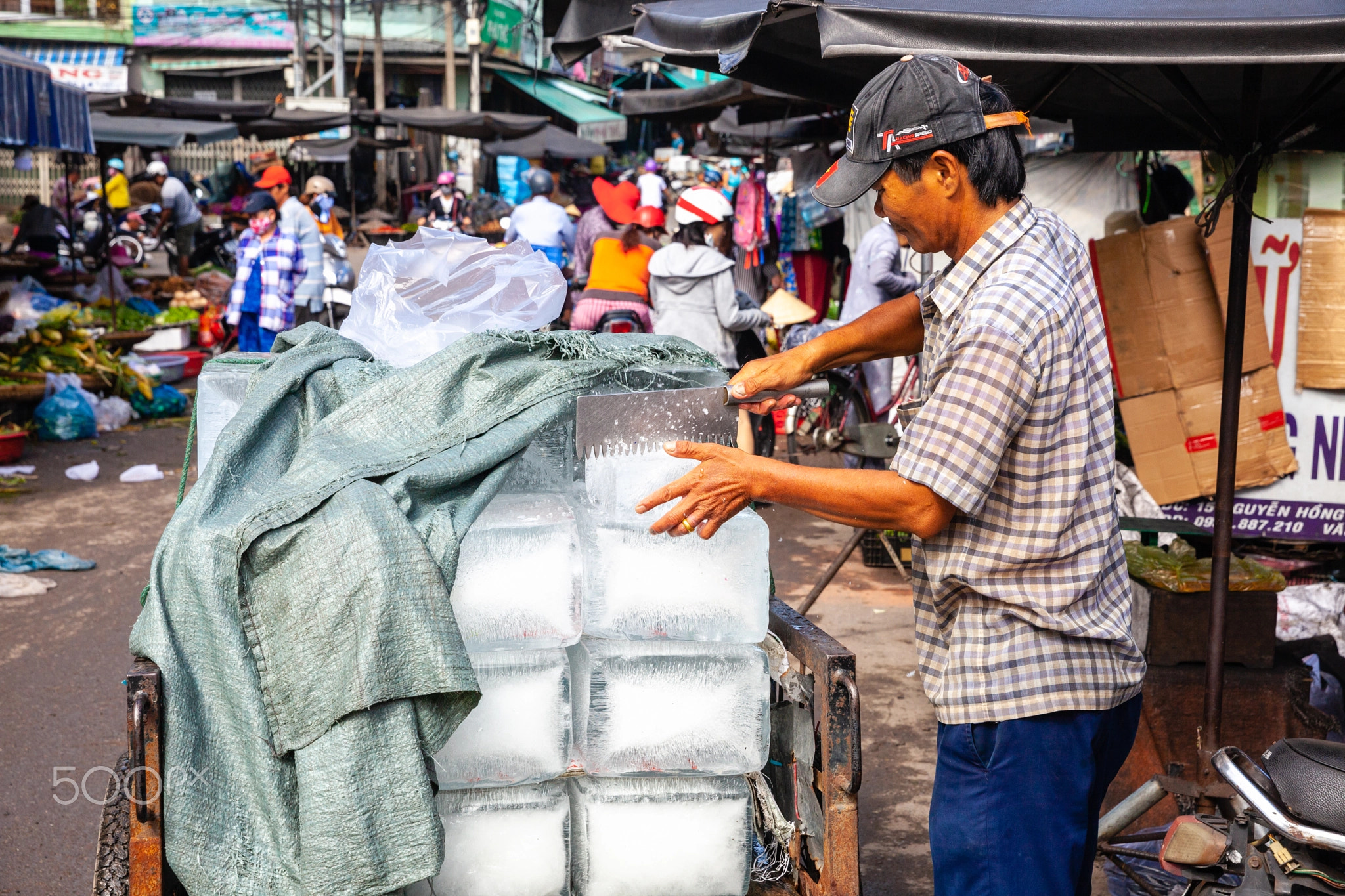 A Vietnamese man sells ice at the Cho Dam market in Nha Trang, V