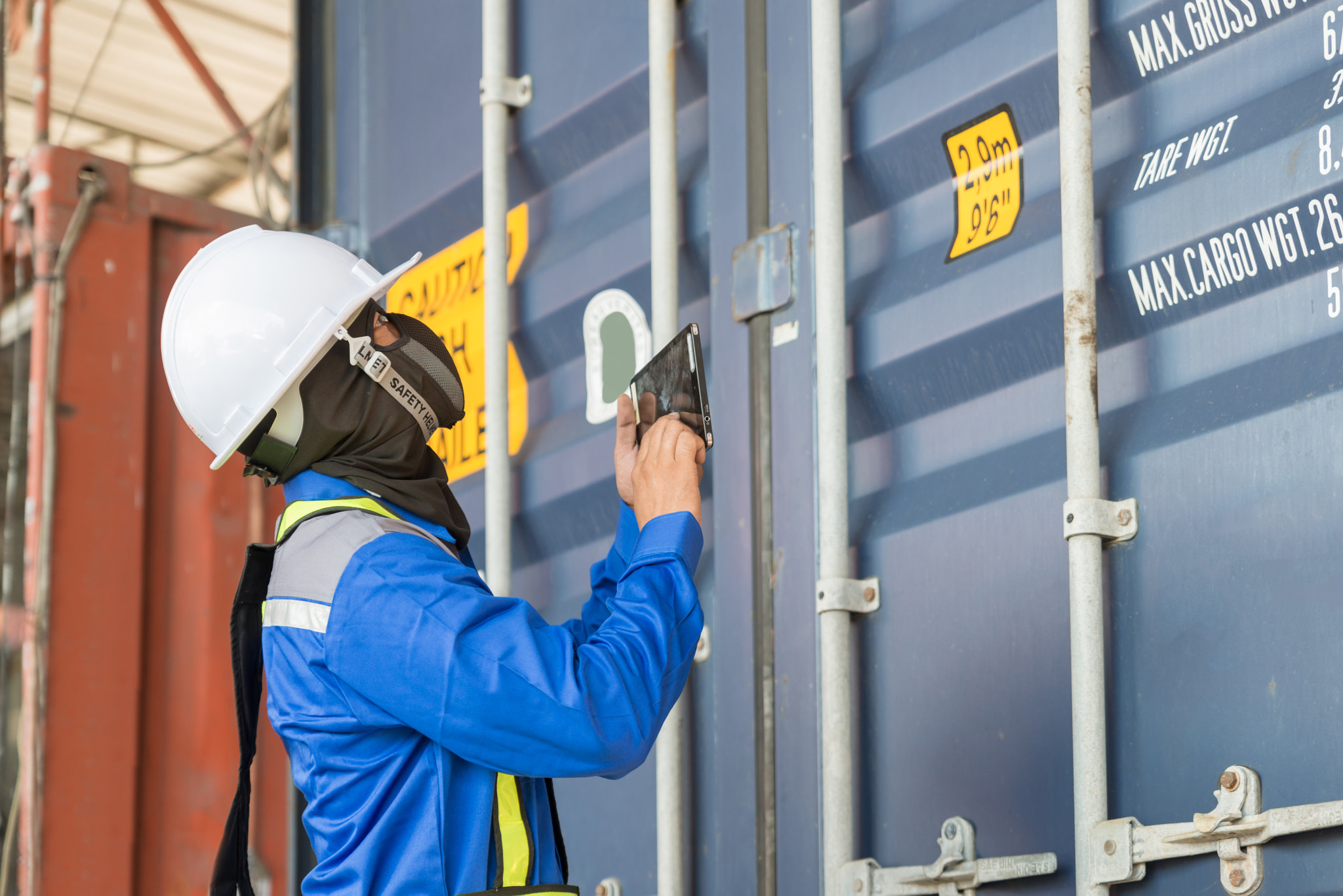 Foreman control loading Containers box from Cargo freight ship f