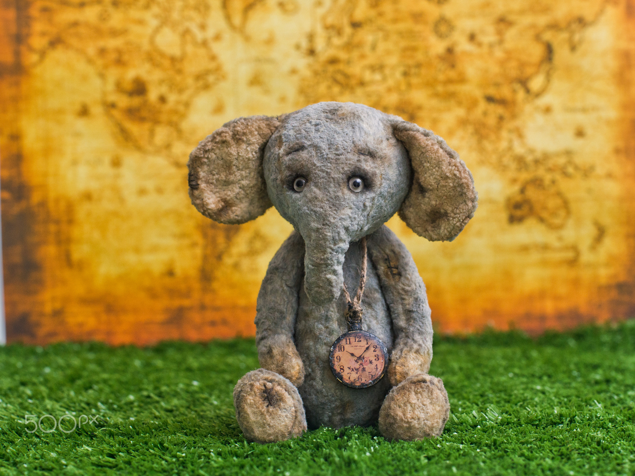 Plush Elephant on the background of an old world map