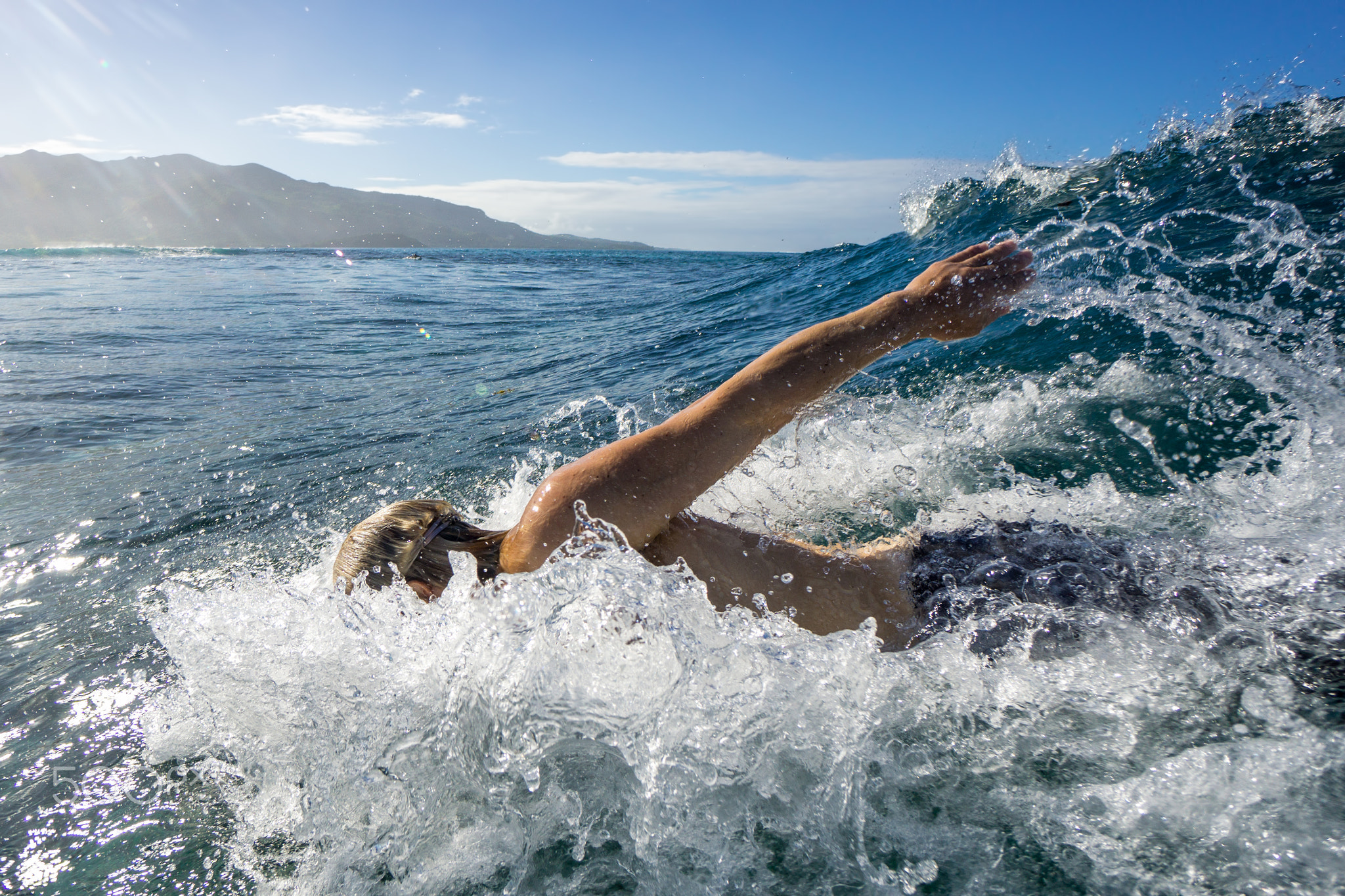 Bodysurfer swims in the waves of Mauritius