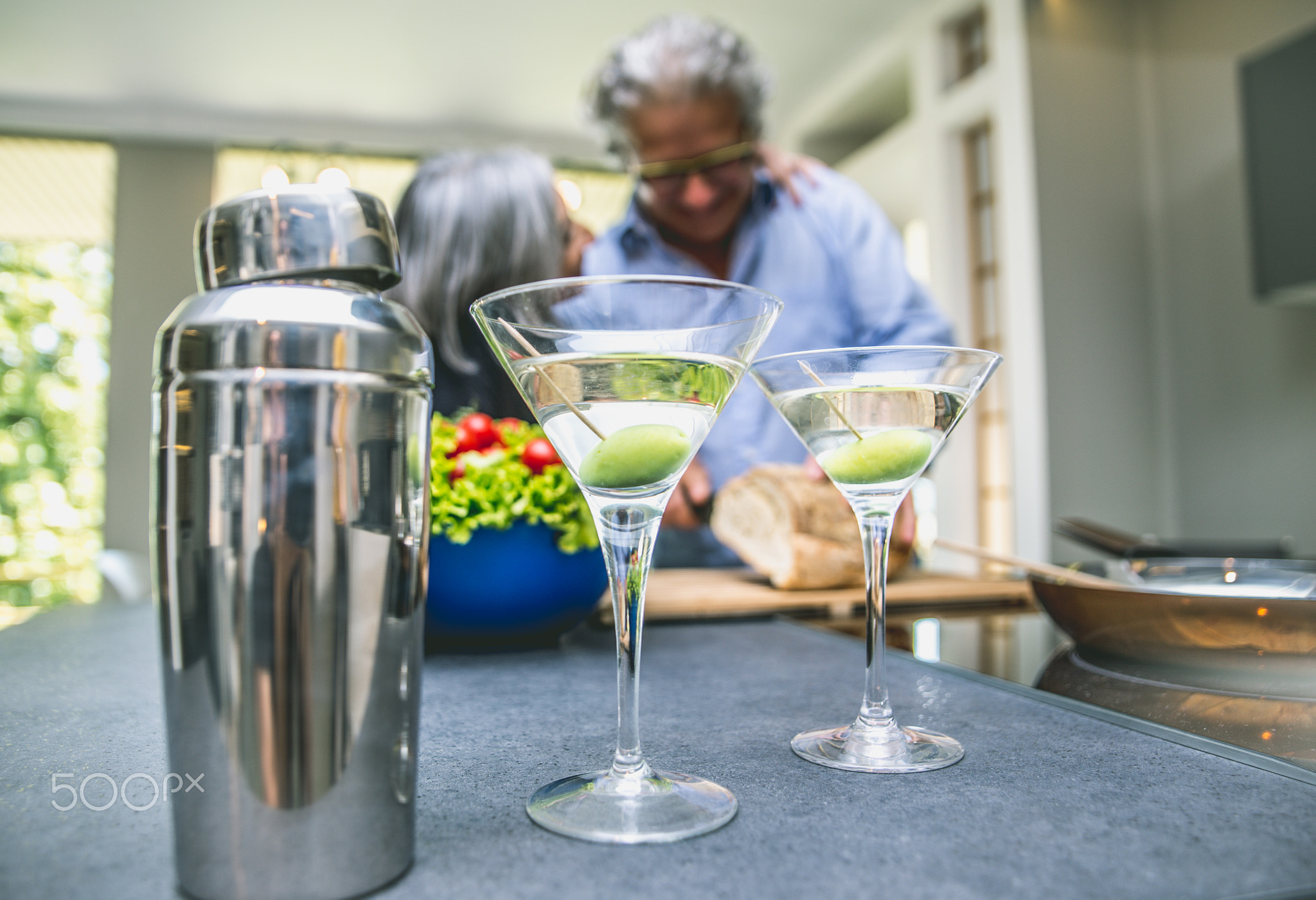 Senior couple cooking and having fun in the kitchen