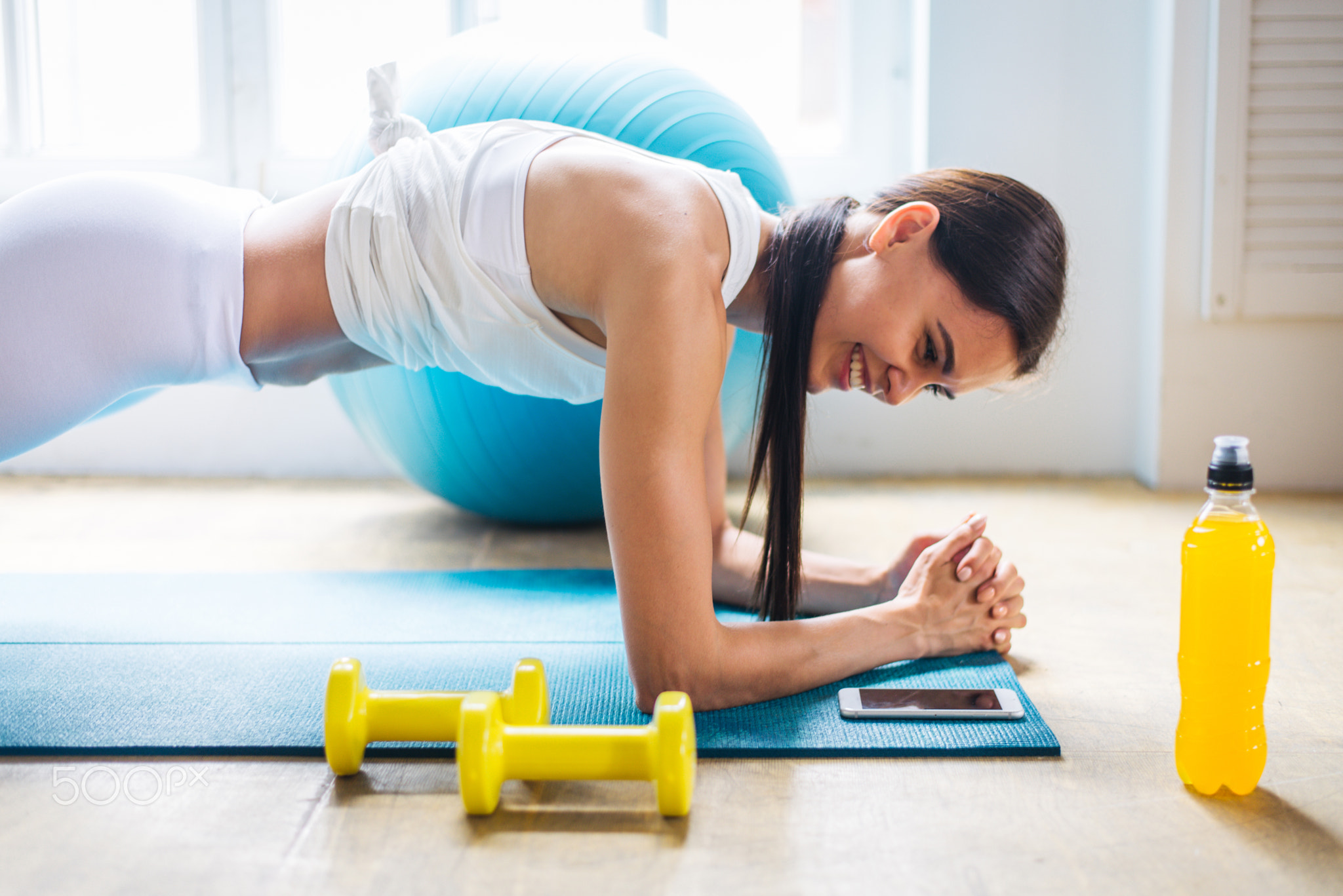 Sportive woman training at home