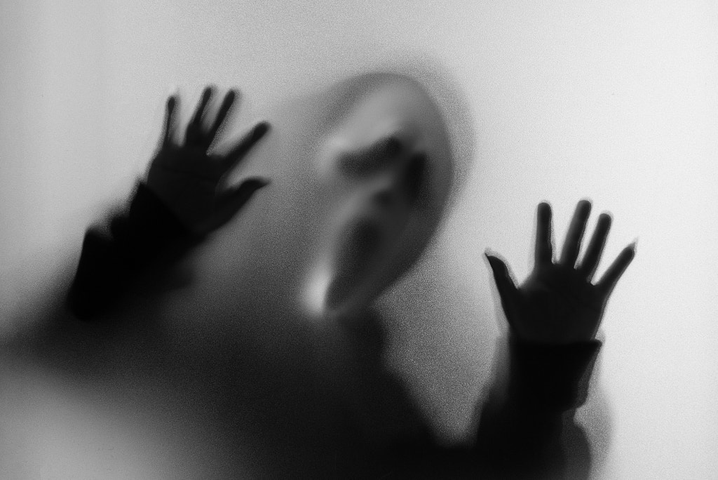 Shadow blur of horror man in screaming mask and hand touches the by Chayapon Bootboonneam on 500px.com