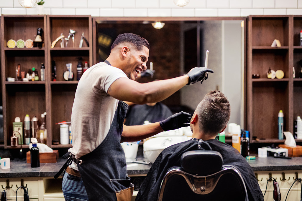 Rear view of man client visiting haidresser and hairstylist in barber shop. by Jozef Polc on 500px.com