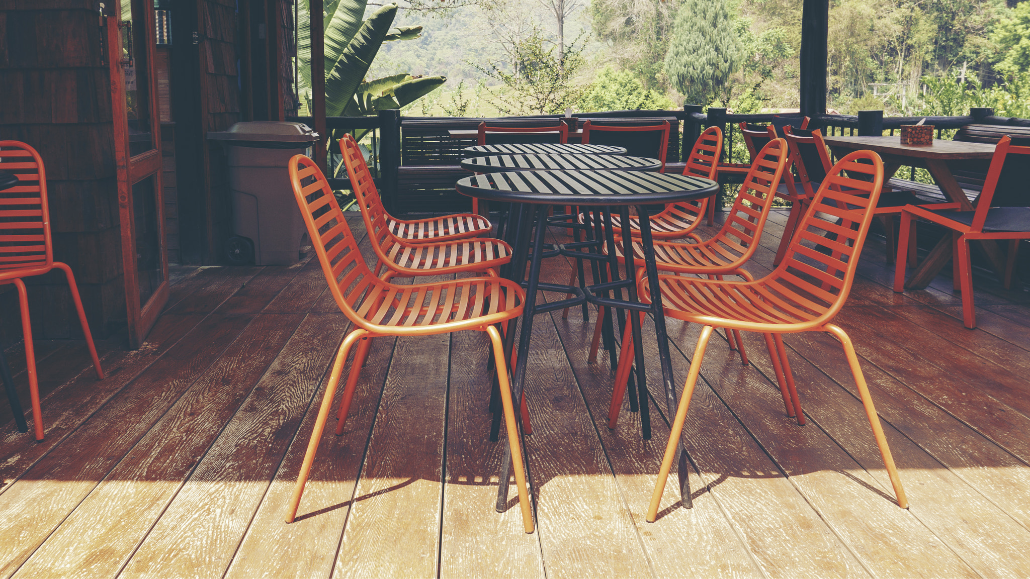 Orange outdoor table & chairs in bistro café in daytime for relaxation, travel, season, time,...