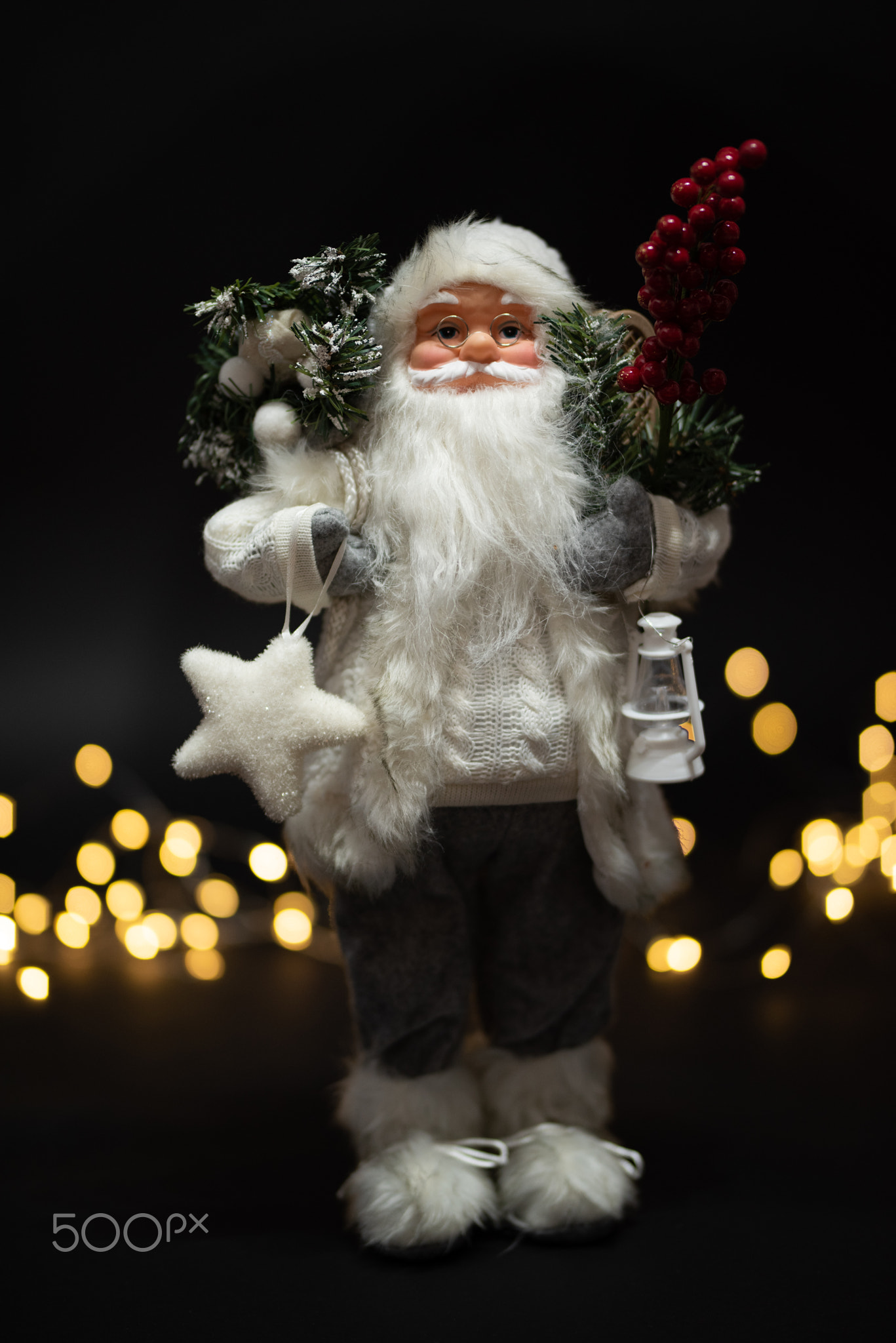 Santa Claus shot against dark background with magical golden bokeh