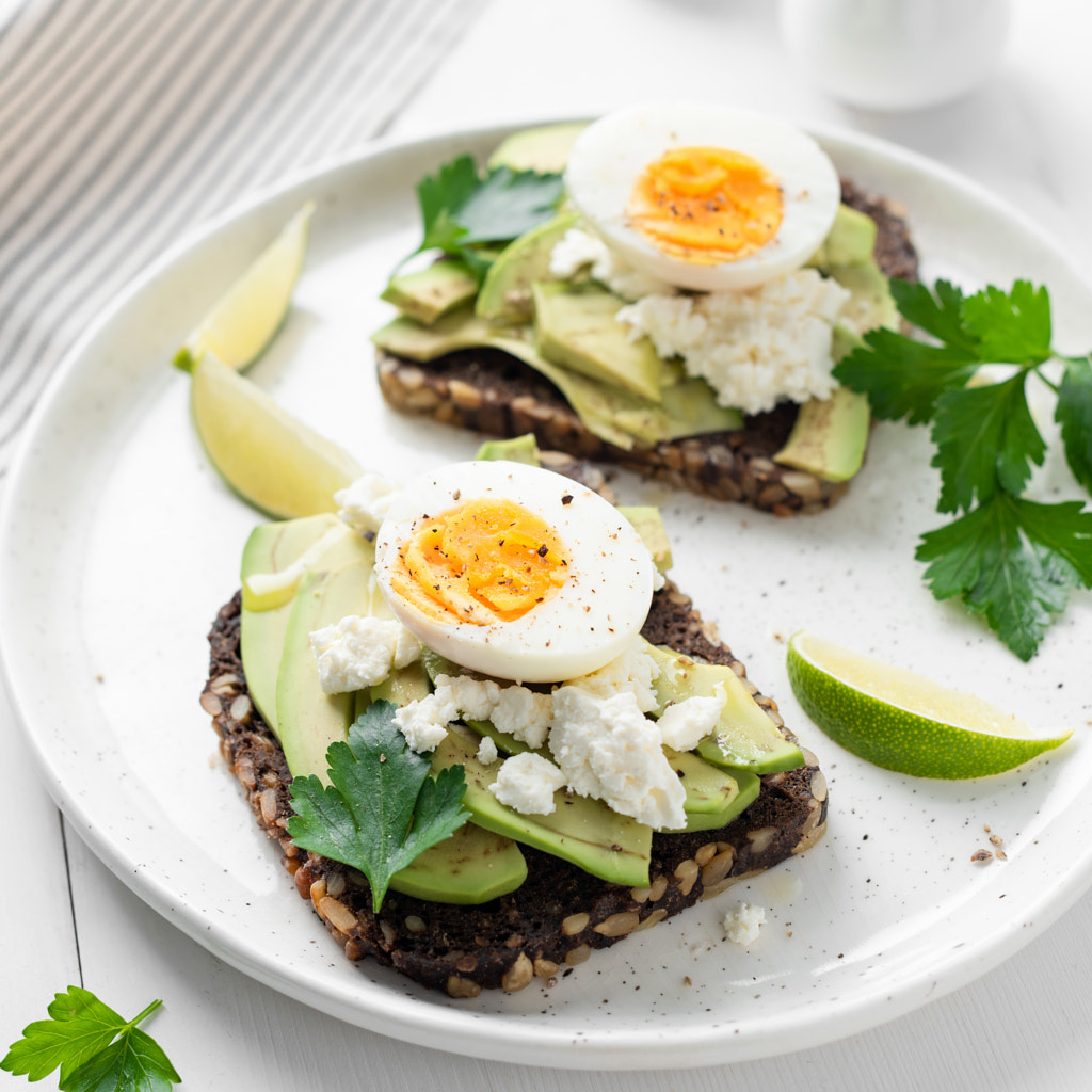 Toast with avocado, feta cheese and boiled egg by Vladislav Nosick on 500px.com