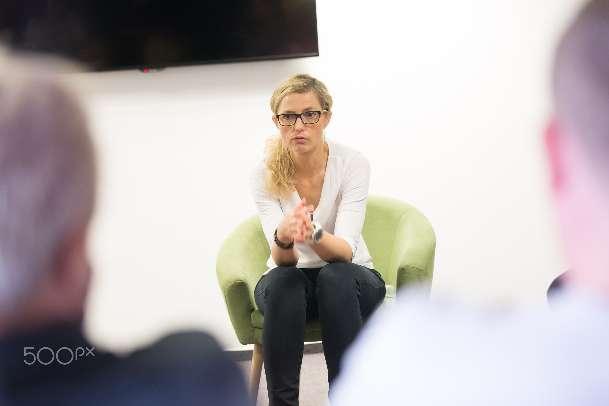 Female candidate presenting her CV in front of business job recuters during job interview in office.