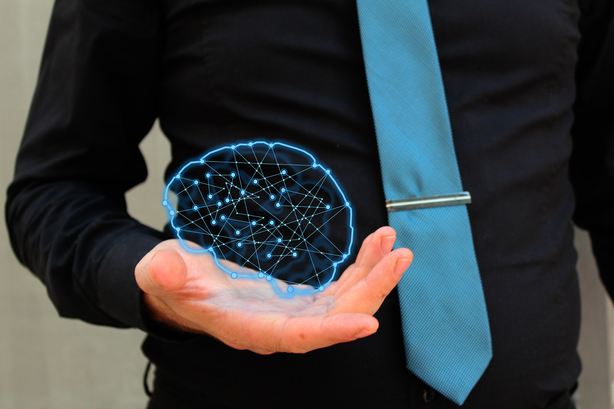 Man holding glowing polygonal brain . Artificial intelligence and mind concept