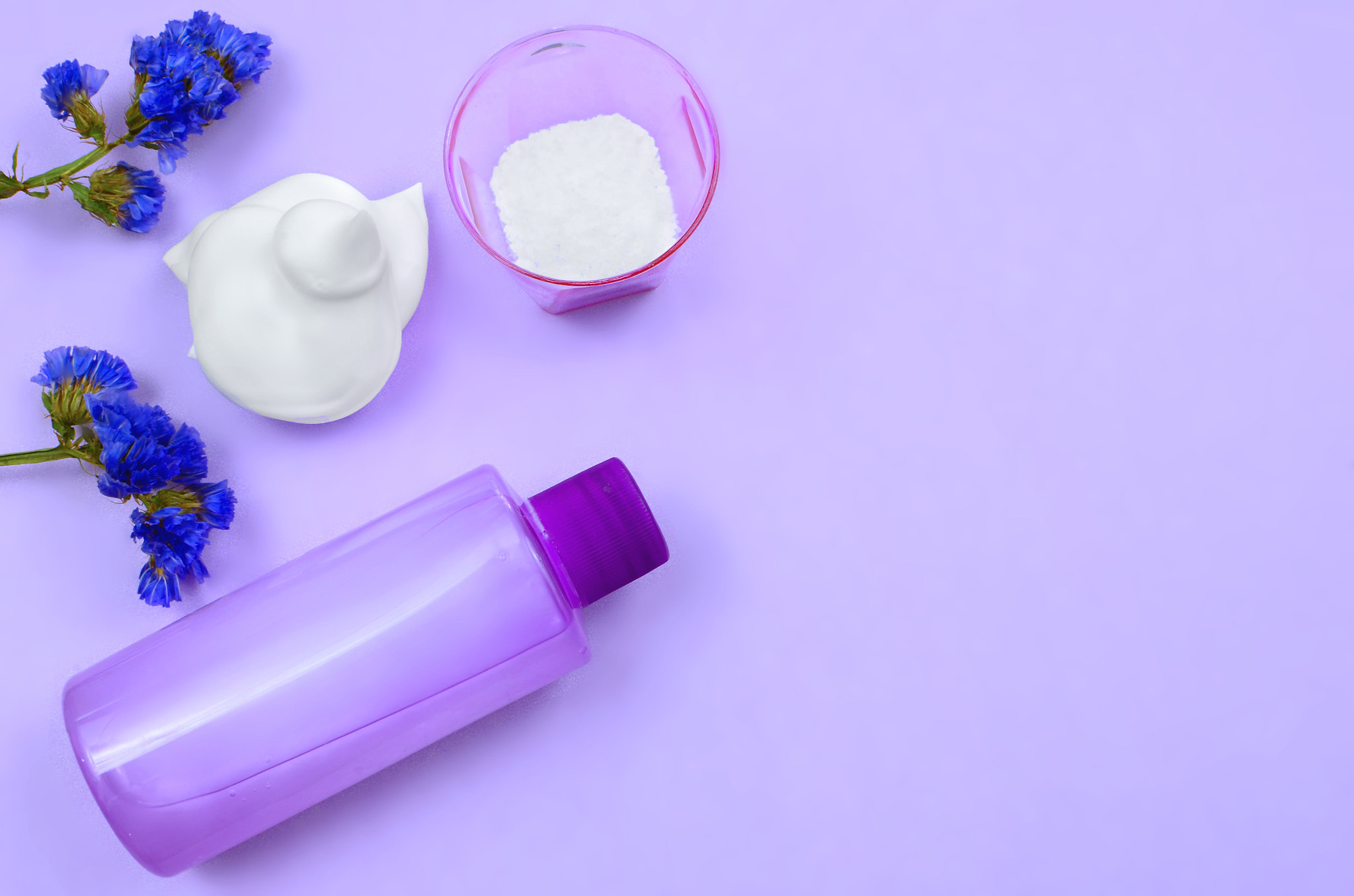 Various hair and body beauty products in shades of ultra violet. Overhead perspective with copy...