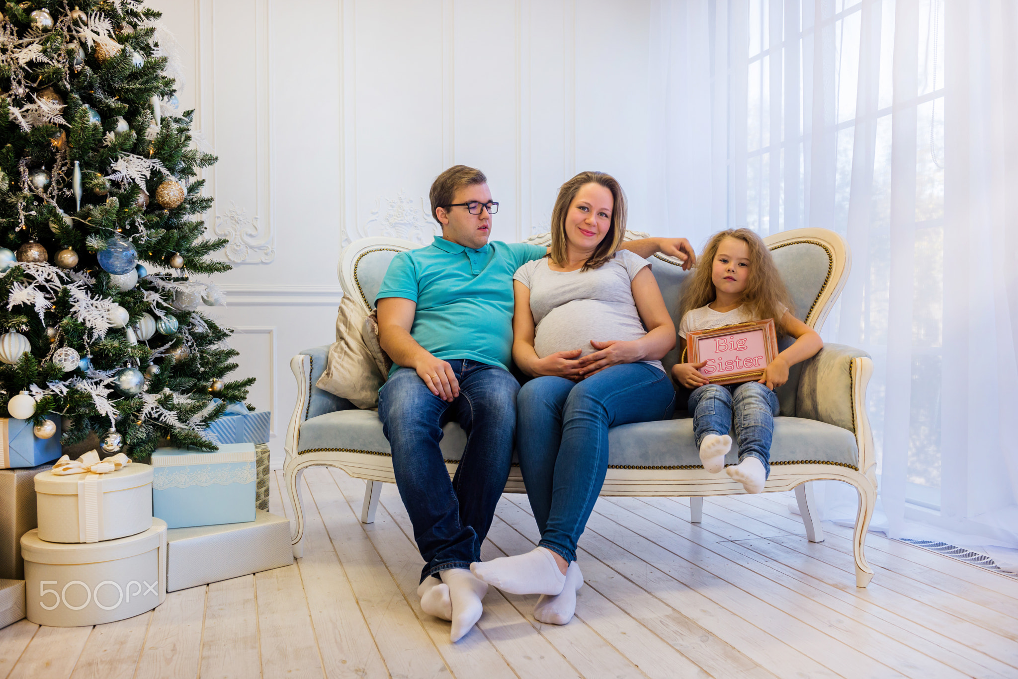 Family portrait near christmas tree