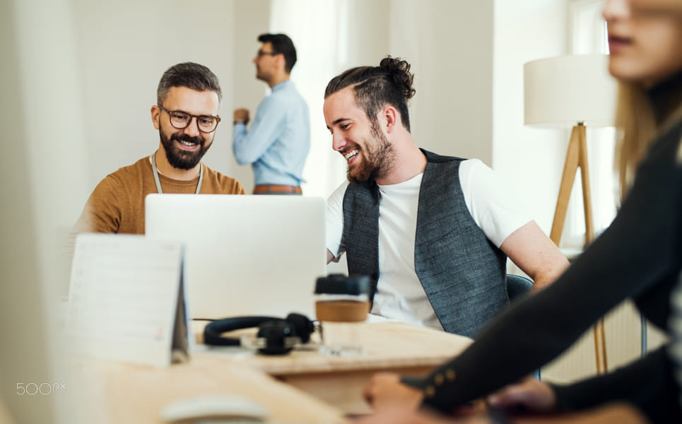 Group of young businesspeople with laptop working together in a modern office. by Jozef Polc on 500px.com