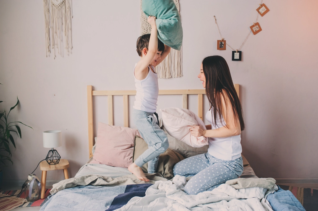 happy mother and child son playing pillow fight in bed in early morning. Family casual lifestyle... by Maria Kovalevskaya on 500px.com