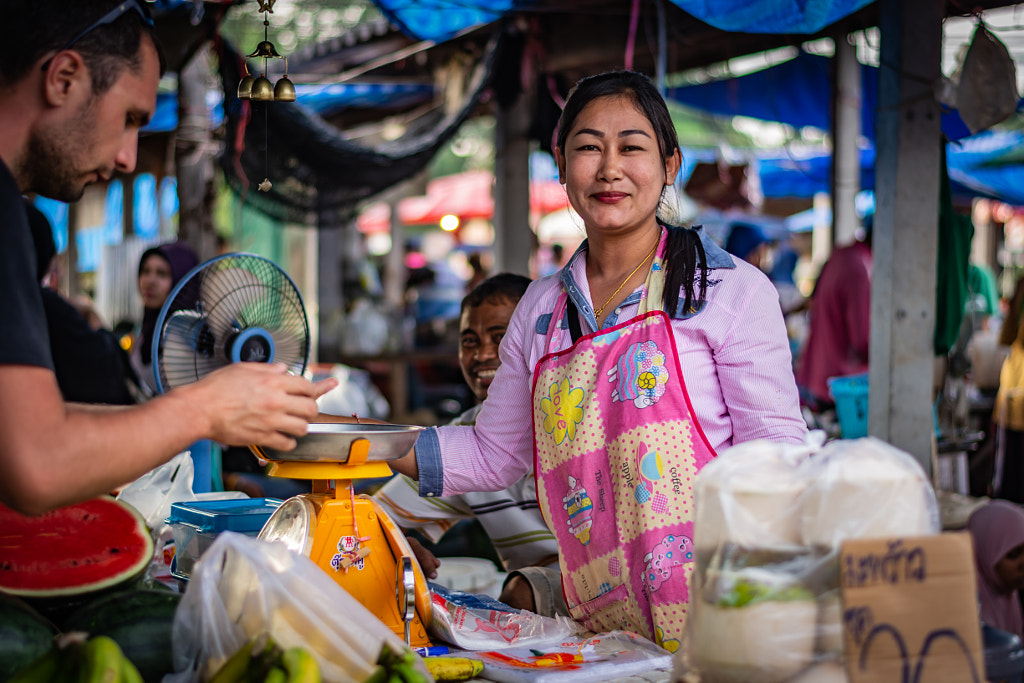 Young woman sells fruit at a market by Radek Ziemniewicz on 500px.com