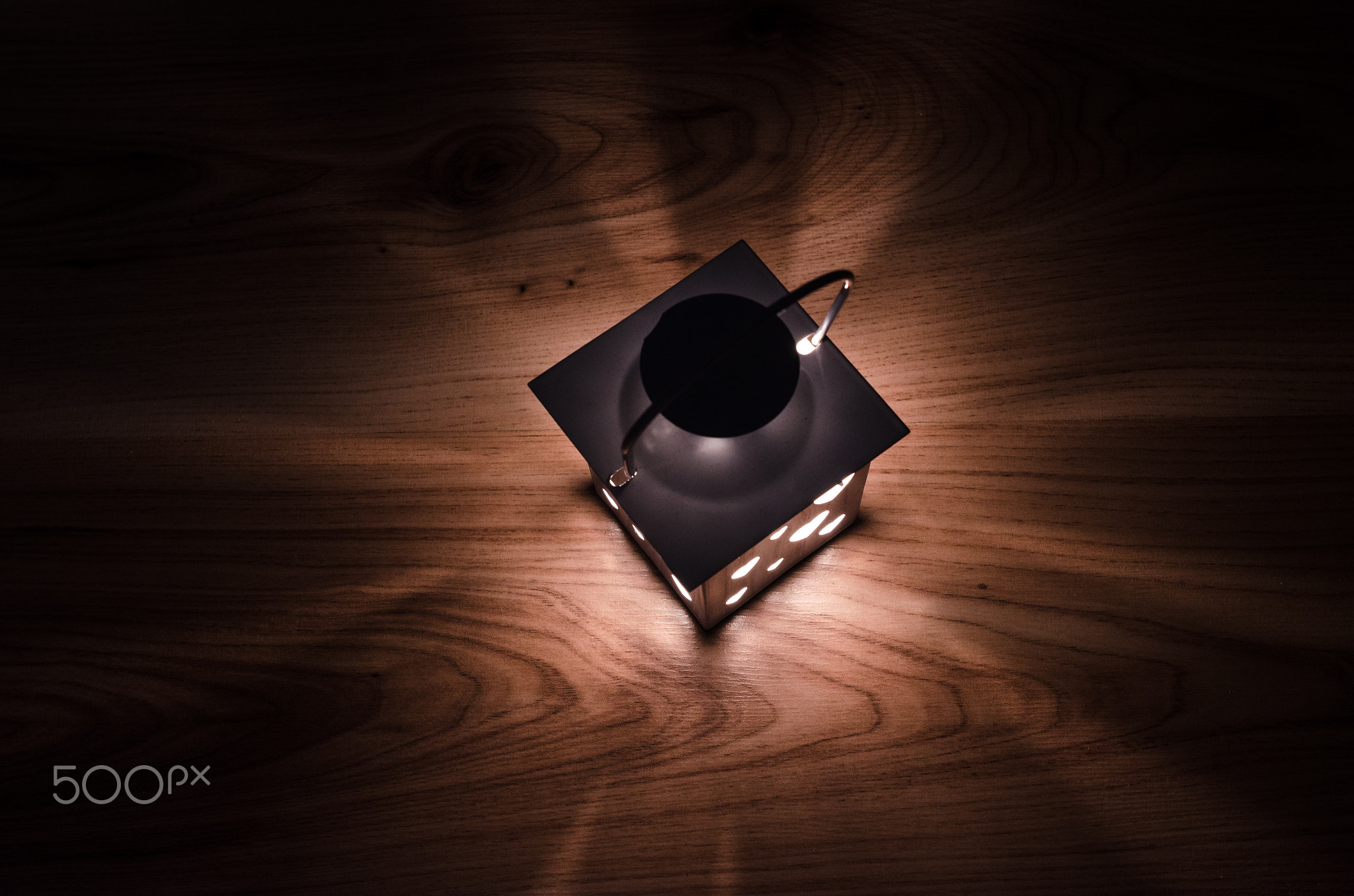 Lantern glow on wood background