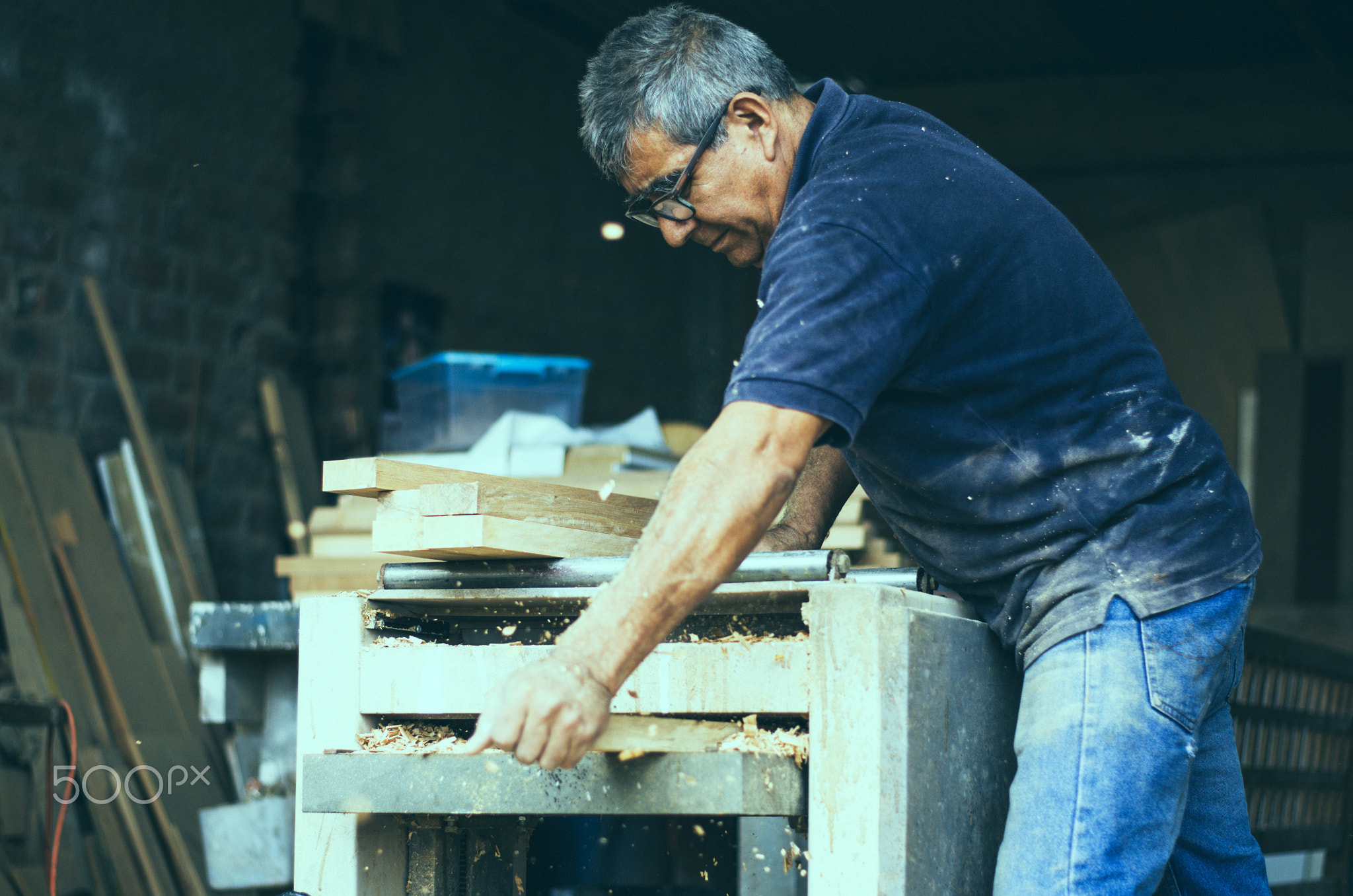 Carpenter using belt sander. Carpenter sanding a wood