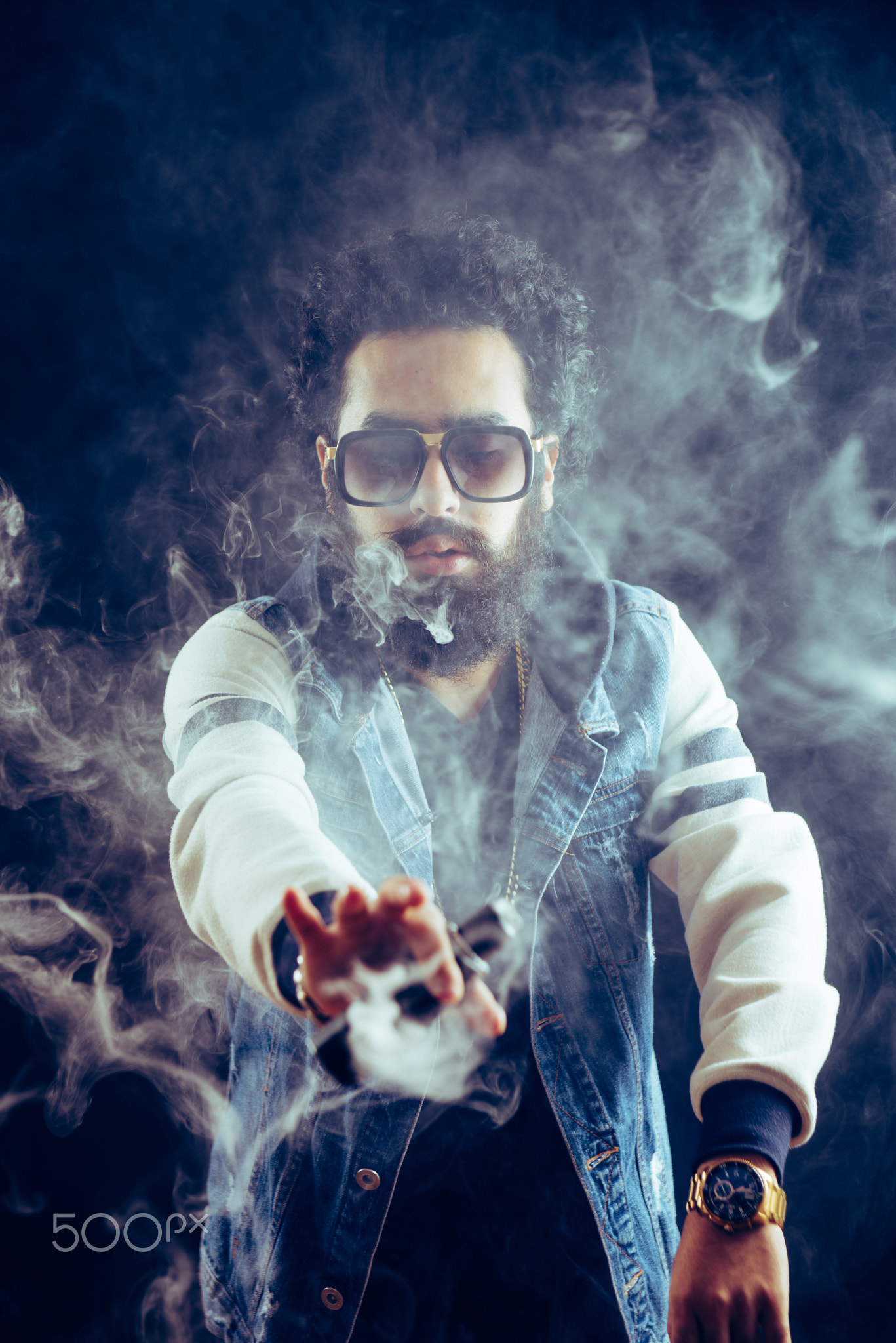 Smoking vape. vaping man holding a mod. Vape Rings. A man launches a ring of smoke.