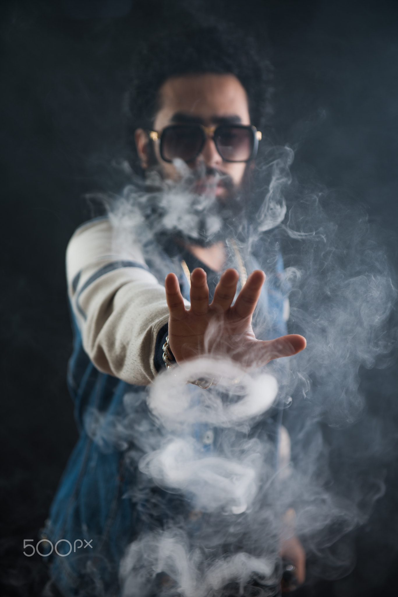 Smoking vape. vaping man holding a mod. Vape Rings. A man launches a ring of smoke.