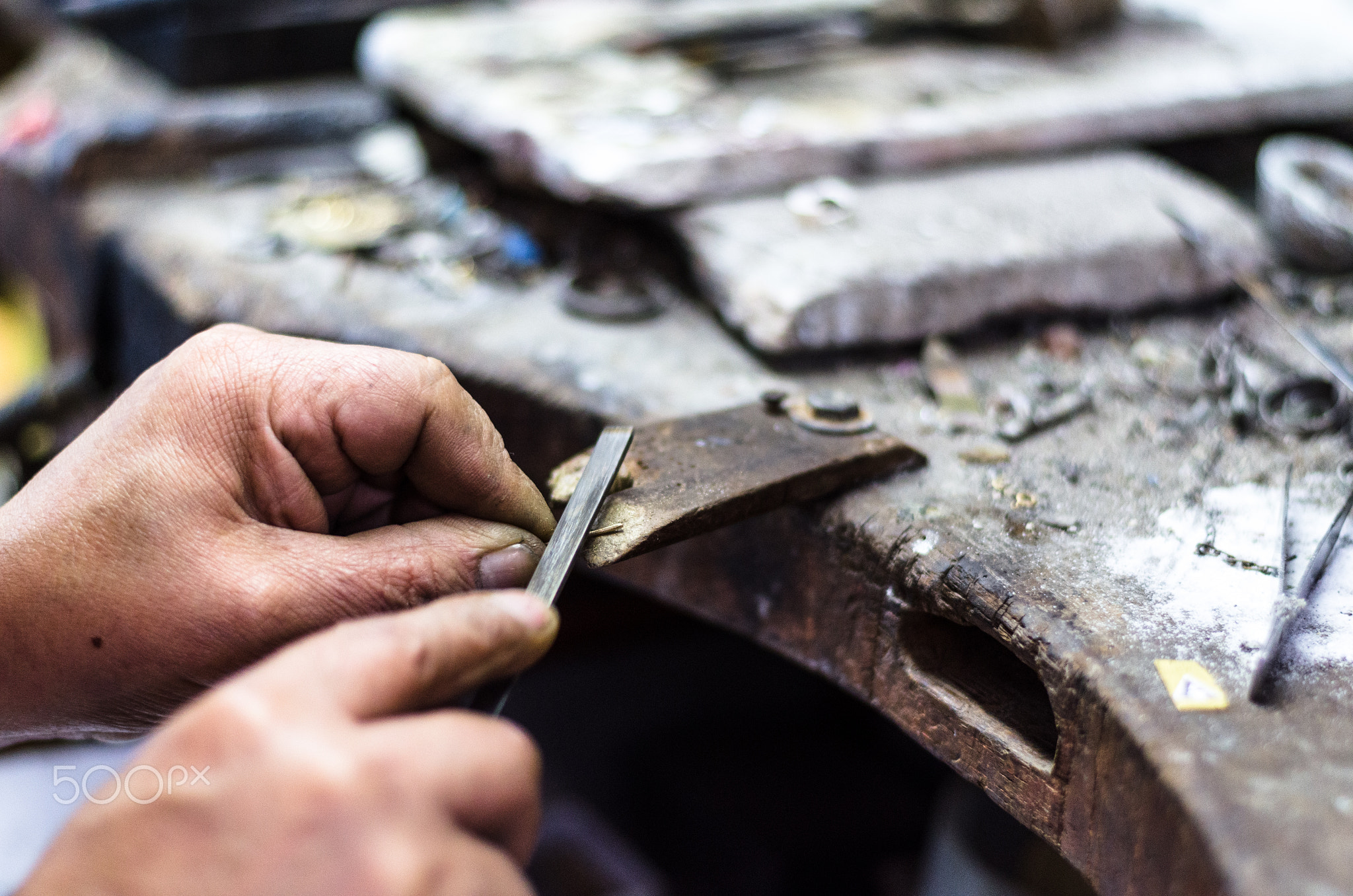 Hands of a jeweler making precious jewelry