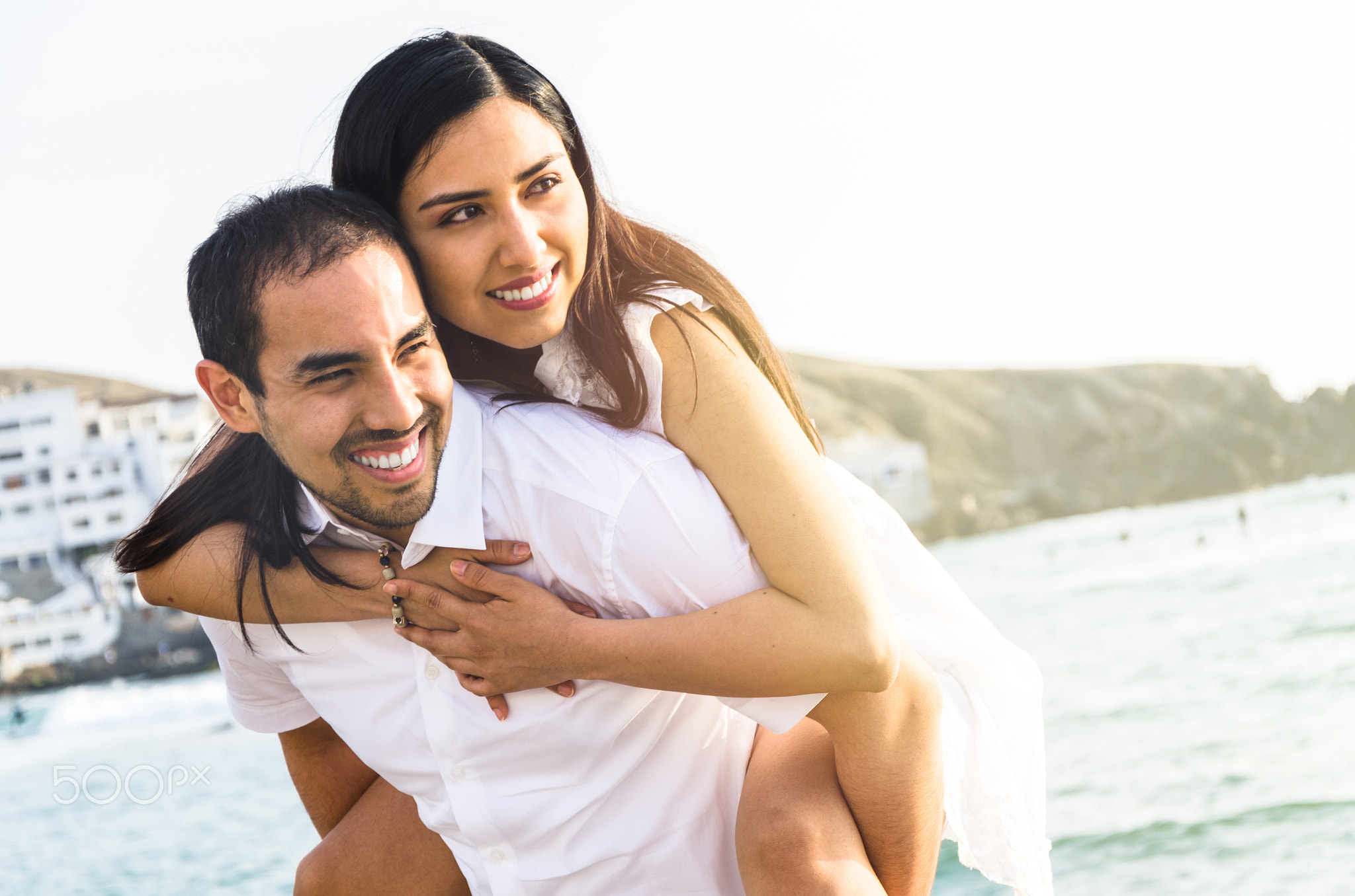 Young man carrying his girlfriend in his arms