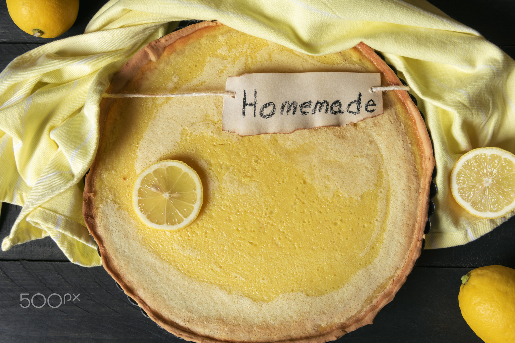 Homemade lemon pie on a yellow towel. Above view of dessert on a
