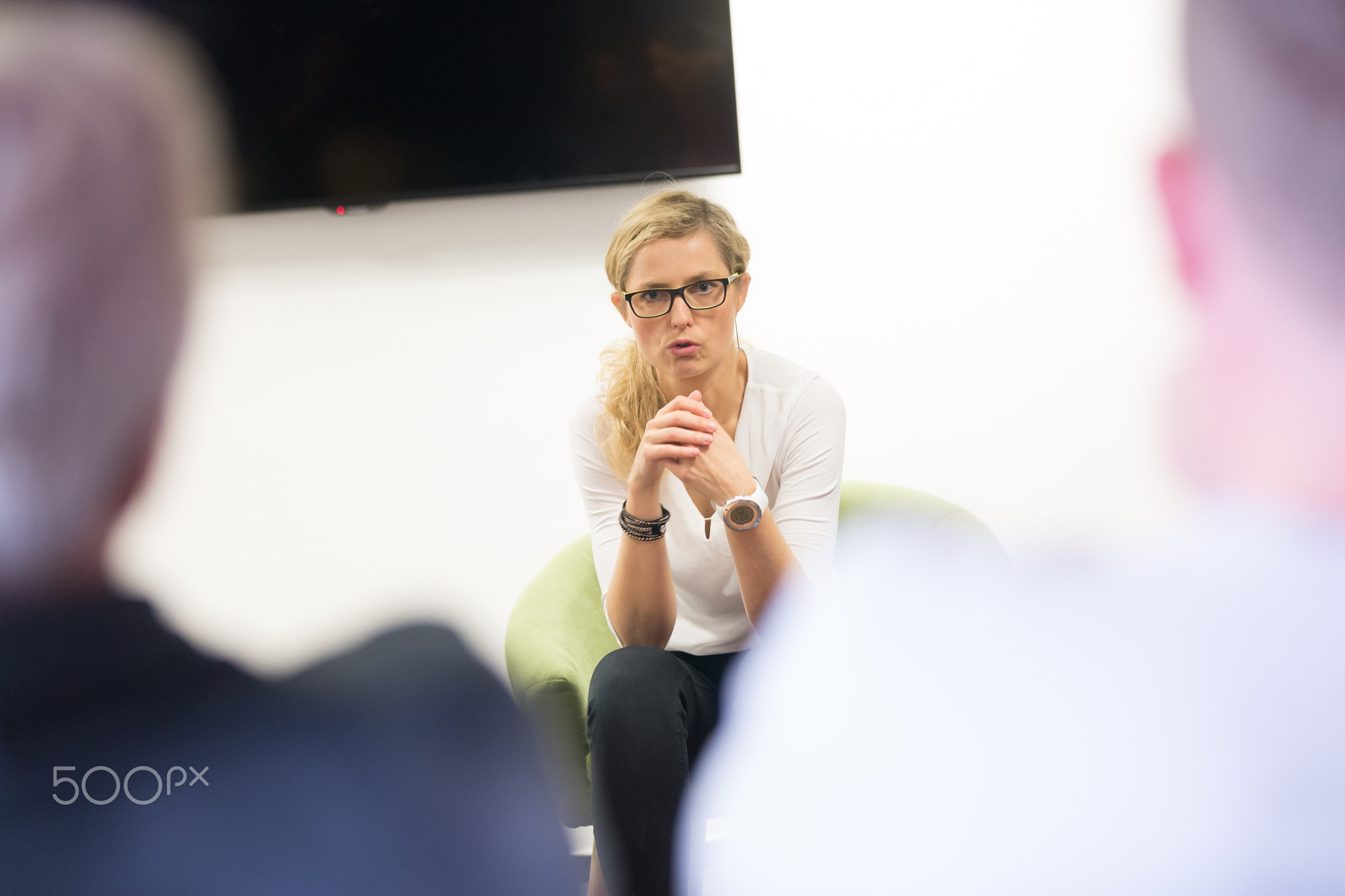 Female candidate presenting her CV in front of business job recuters during job interview in office.