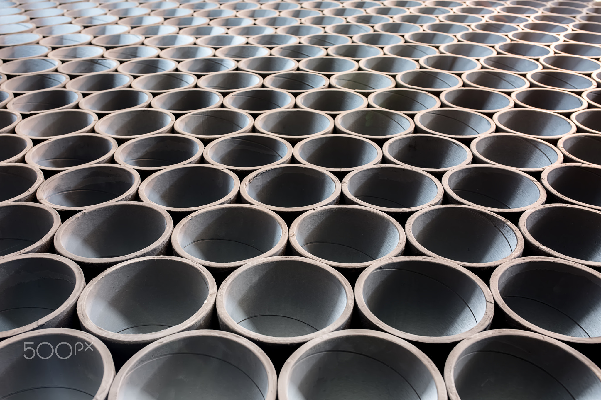 Rows of the gray pipes which lies on each other