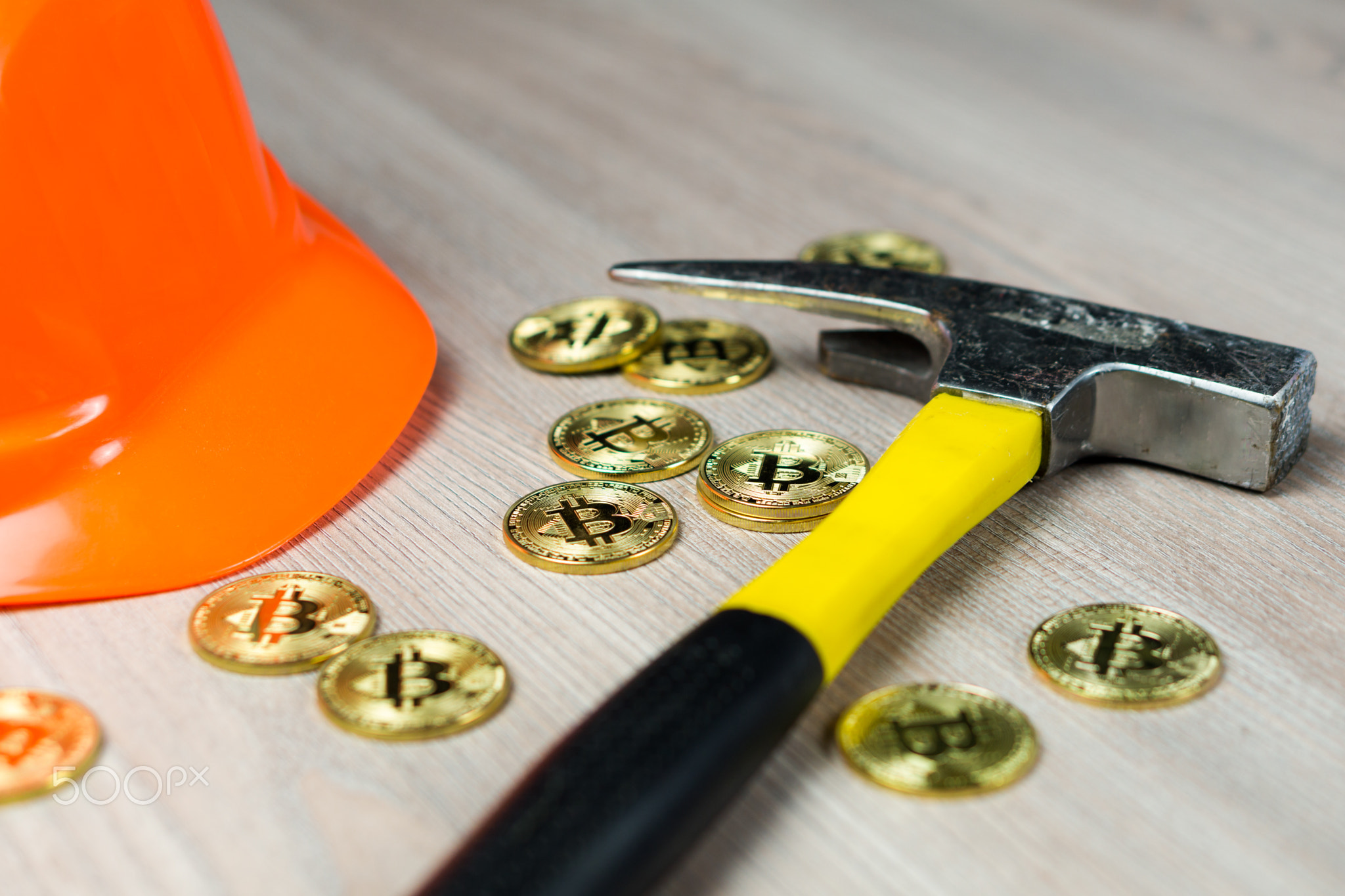 Cryptocurrency bitcoin mining with mining helmet and pickaxe