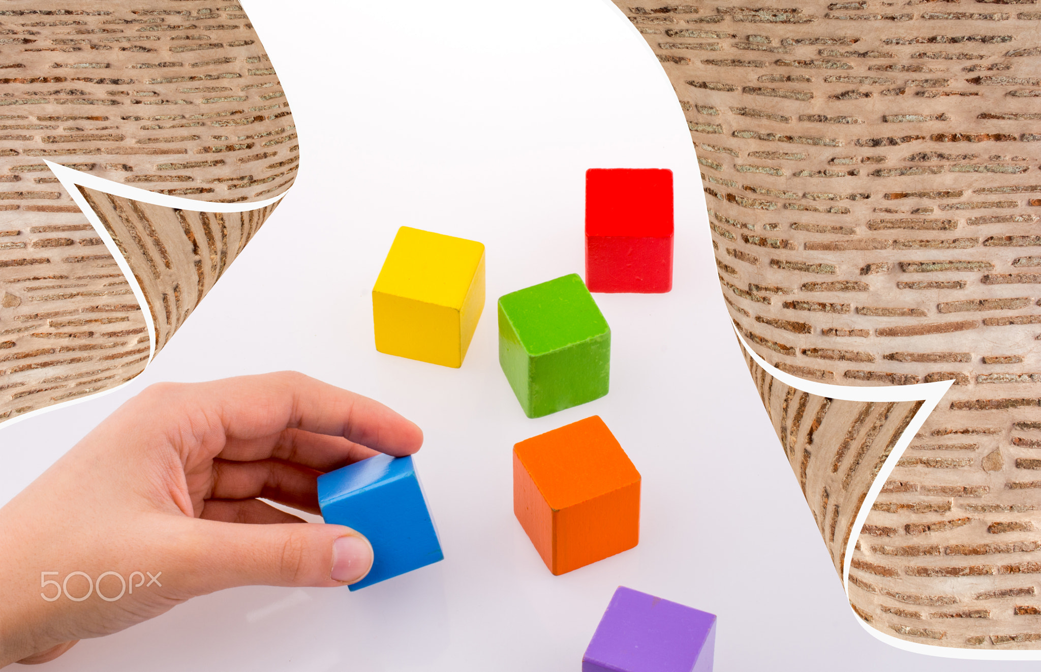 Hand building colorful cubes on a  background